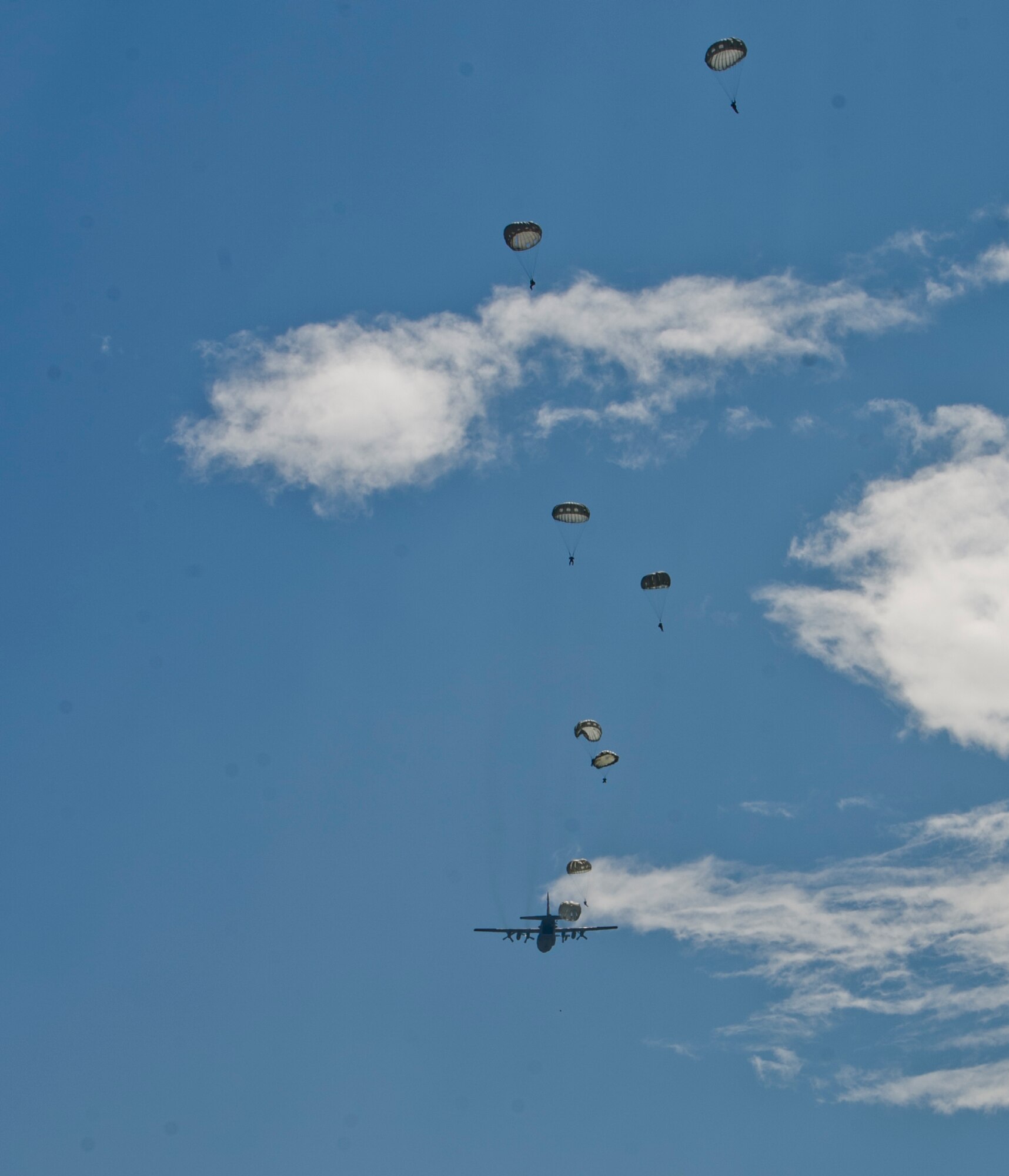 A C-130H Hercules with the Wyoming Air National Guard, 153rd Airlift Wing finishes dropping members of the Special Operations Command (Forward) 7310 and 2nd Honduran Airborne Brigade Jan. 11, 2016, at Soto Cano Air Base, Honduras, during a training mission. The mission is one of many ways the U.S. and Honduras train together to maintain the relationship between the two nations’ service members. (U.S. Air Force photo by Capt. Christopher Mesnard/Released)