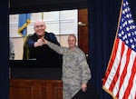 Defense Logistics Agency Aviation Commander Air Force Brig. Gen. Allan Day presents Gregory LaRue with a commander’s coin during a video teleconference Jan. 6, 2016. LaRue is a material support technician for the Customer Operations Directorate of DLA Aviation at Ogden, Utah, and is DLA Aviation’s November Employee of the Month. 
