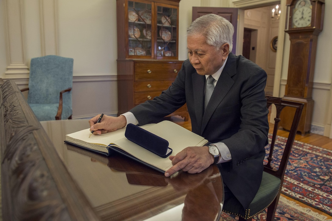 Philippine Foreign Secretary Albert del Rosario signs a guest book as he arrives at the State Department to meet with Secretary of State John Kerry and Defense Secretary Ash Carter, Jan. 12, 2016. The leaders met to discuss matters of mutual importance. DoD photo by Air Force Senior Master Sgt. Adrian Cadiz