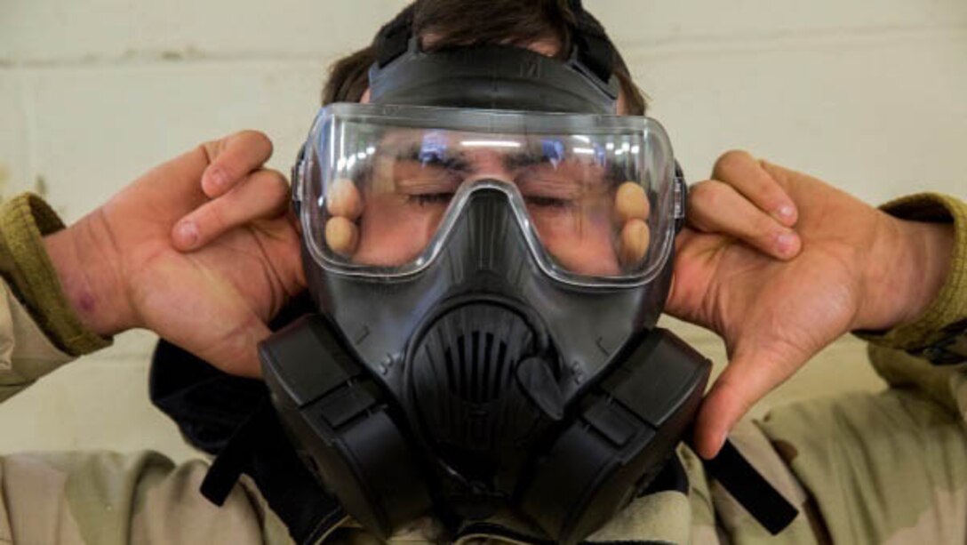 A Marine with 2nd Marine Logistics Group breaks the seal on his mask after entering the gas chamber at Marine Corps Base Camp Lejeune, N.C., Jan. 8, 2016. Marines, while exposed to chlorobenzylidene malononitrile, or CS gas, must conduct a series of exercises before breaking the seal on their mask followed by properly don and clearing it. The chamber is a routine exercise to ensure the durability of each Marines gear while exposed to chlorobenzylidene malononitrile, or CS gas, which is a bi-annual qualification requirement for Marines.