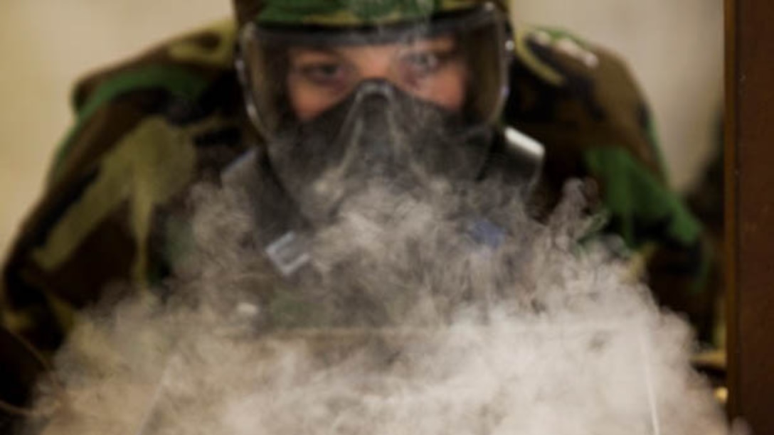 Lance Cpl. Jamie Roper, a chemical, biological, radiological, and nuclear Marine with Headquarters Company, 2nd Marine Logistics Group, disperses chlorobenzylidene malononitrile, or CS gas, in preparation for gas chamber bi-annual qualification at Marine Corps Base Camp Lejeune, N.C., Jan. 8, 2016.  The chamber is a routine exercise to ensure the durability of each Marines gear while exposed to CS gas.