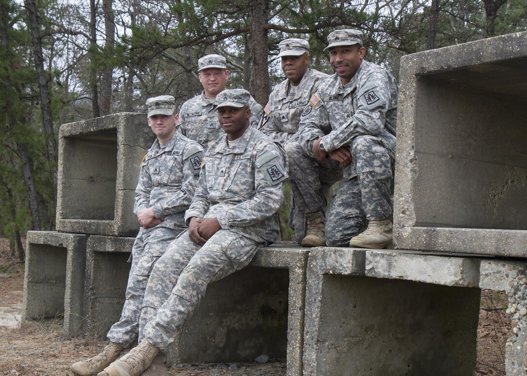 Army Reserve Soldiers assigned to the Cumberland, Maryland-based 372nd Military Police Company (from left to right), Sgt. Jonah Rock, an MP from Hagerstown, Md.; Sgt. Sean McCarthy, a signal support systems specialist, from Martinsburg, W. Va.; Cpl. Aaron Dabney, an internment and resettlement specialist from Alexandria, Va.; Sgt. Regginald Brown, an MP from Clifton, N.J.; and Sgt. Eric Blake, an MP from Aberdeen, Md.; pose for a picture during battle assembly Jan. 9, 2016, at Joint Base McGuire-Dix-Lakehurst, N.J. The Soldiers, along with Sgt. Kori Leopoldo, apprehended a robbery suspect Dec. 12 after leaving a CVS in Pemberton Township, N.J., during their annual training at JBMDL. (U.S. Army Reserve photo by Sgt. 1st Class Jacob Boyer/Released)