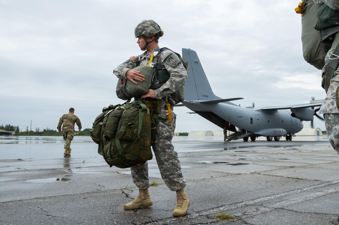 A soldier checks her parachute and equipment before participating in an airborne operation over Homestead Air Reserve Base, Fla., Jan. 12, 2016. U.S. Army photo by Staff Sgt. Osvaldo Equite