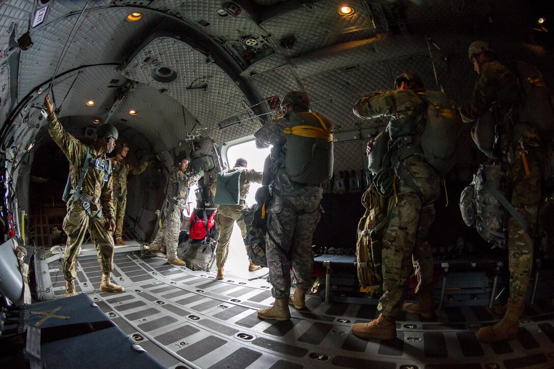 An Army jumpmaster observes the drop zone as soldiers wait for the green light during an airborne operation over Homestead Air Reserve Base, Fla., Jan. 12, 2016. U.S. Army photo by Staff Sgt. Osvaldo Equite