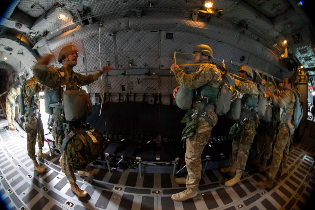 An Army jumpmaster yells the command "check equipment” to his paratroopers during an airborne operation over Homestead Air Reserve Base, Fla., Jan. 12, 2016. U.S. Army photo by Staff Sgt. Osvaldo Equite