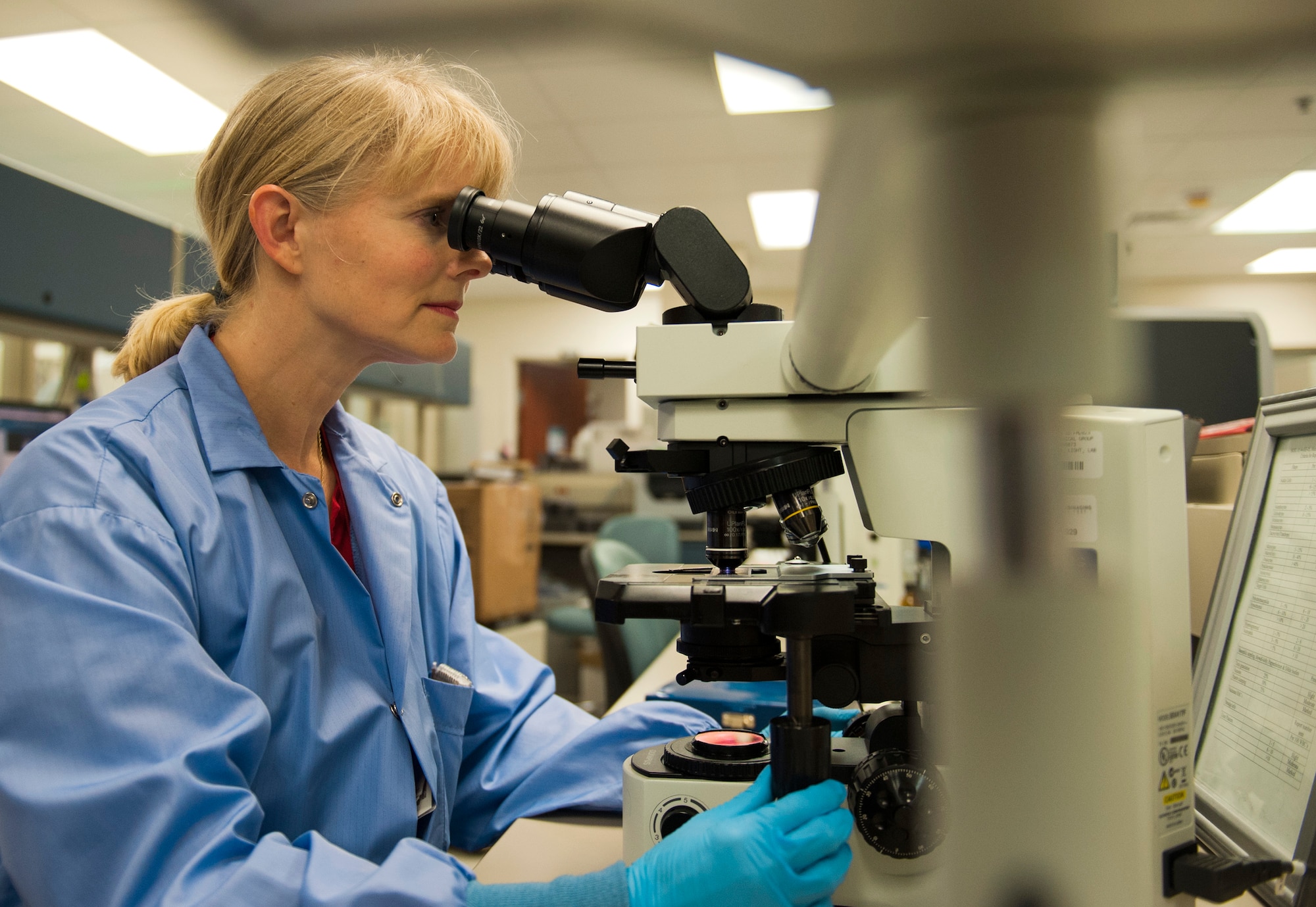 Dolli Lane, a 96th Medical Group laboratory technician, reviews a sample through the microscope Nov.19, 2015, at Eglin Air Force Base, Fla. Lane spotted a rare spirally twisted bacteria when reviewing a sick patient’s malaria smear. The sample provided by the 96th MDG lab was the first human blood sample of a spirochete bacteria, known to cause tick-borne relapsing fever, to be cultured at the Centers for Disease Control. (U.S. Air Force photo/Ilka Cole)