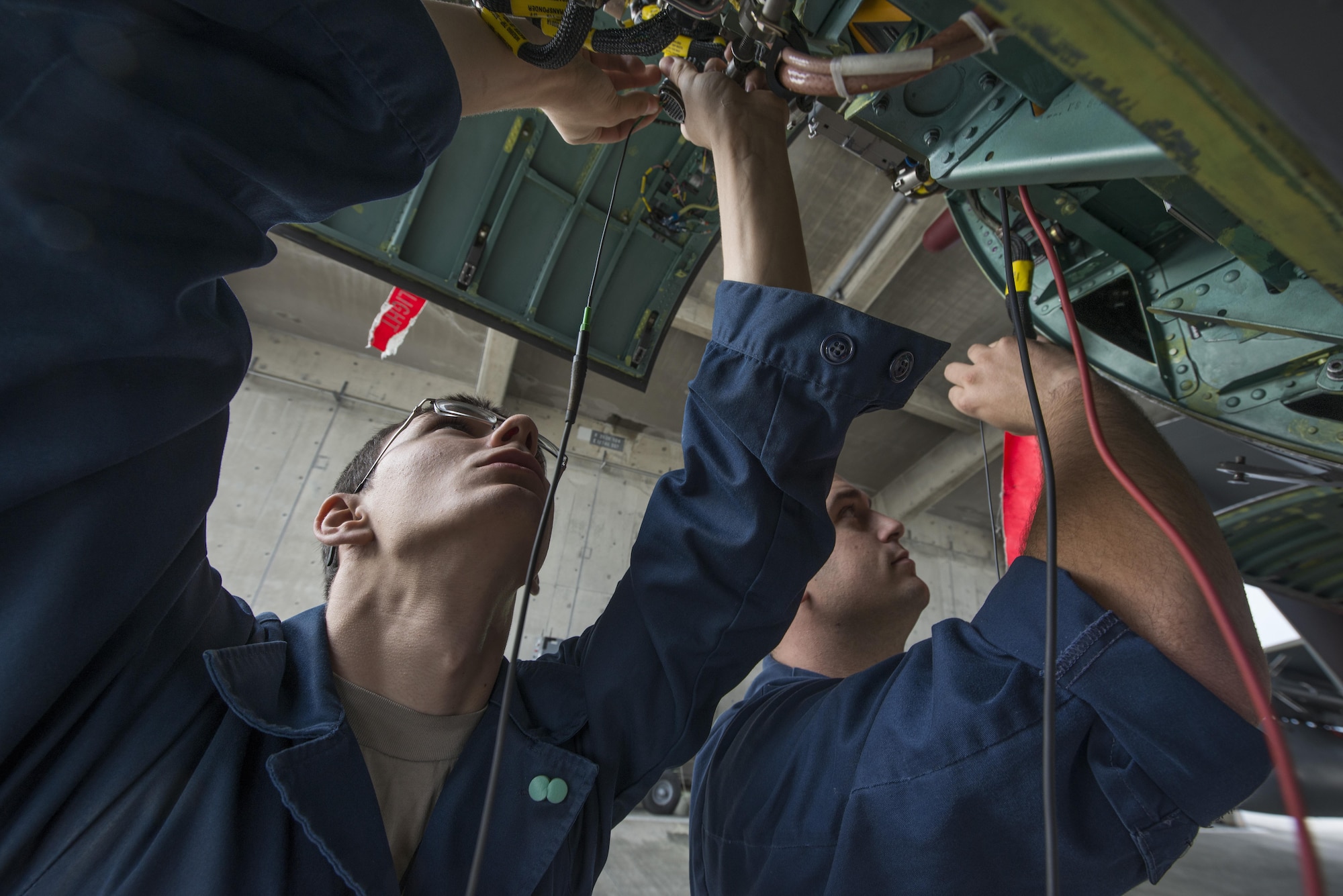 Airman 1st Class Sean Greig and Senior Airman Caleb Stephens, both 67th Aircraft Maintenance Unit avionics specialists, test F-15 Eagle components during maintenance Jan. 8, 2016, at Kadena Air Base, Japan. The two specialists were troubleshooting a problem with the aircraft that limited its ability to measure and display the distance to the airfield. (U.S. Air Force photo/Staff Sgt. Maeson L. Elleman)