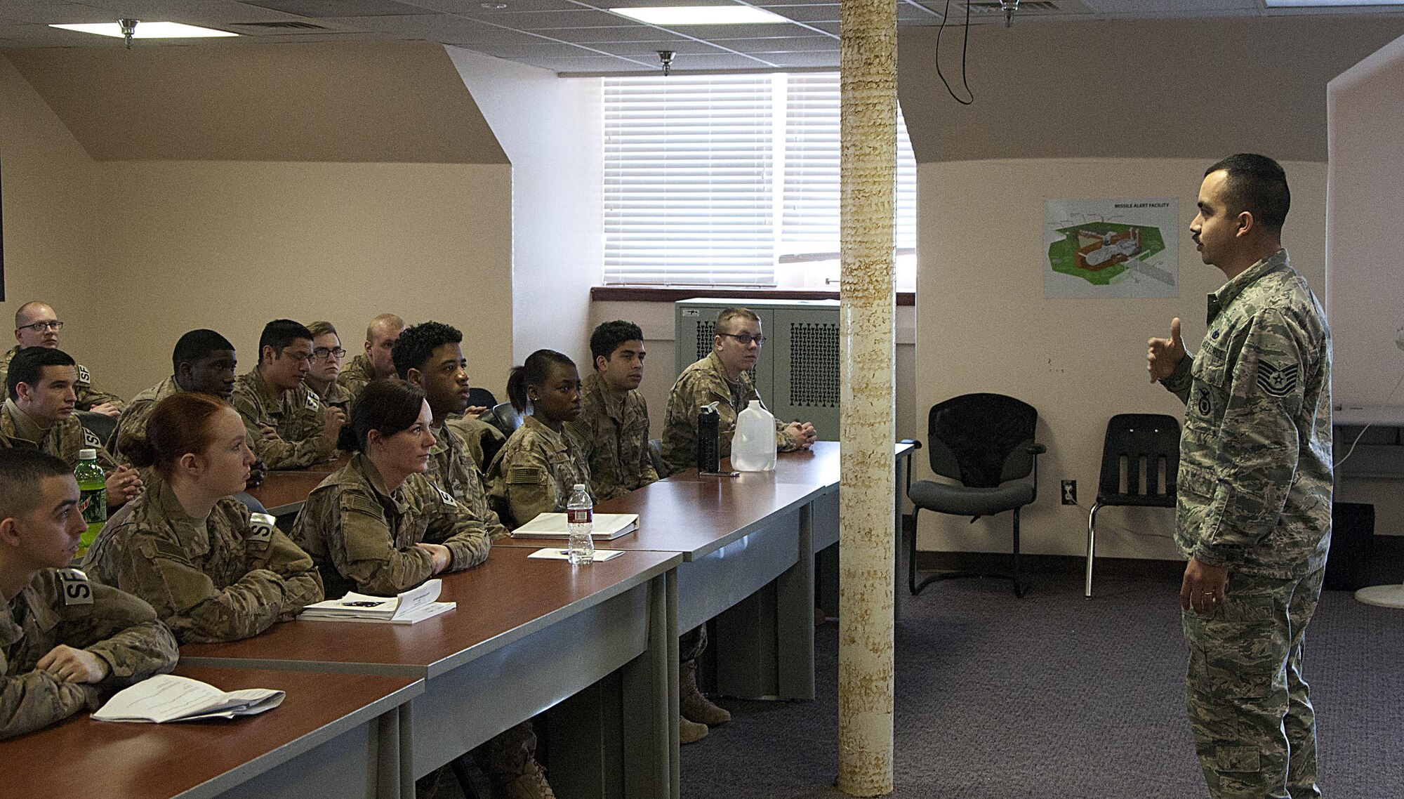 Tech. Sgt. Rene Flores, 90th Missile Security Forces Squadron Training and Validations NCO-in-charge, speaks to security forces Airmen inside the 90th Security Forces Group building on F.E. Warren Air Force Base, Wyo., Jan. 11, 2016, during a 20th Air Force Safety Down-Day. (U.S. Air Force photo by Senior Airman Brandon Valle)