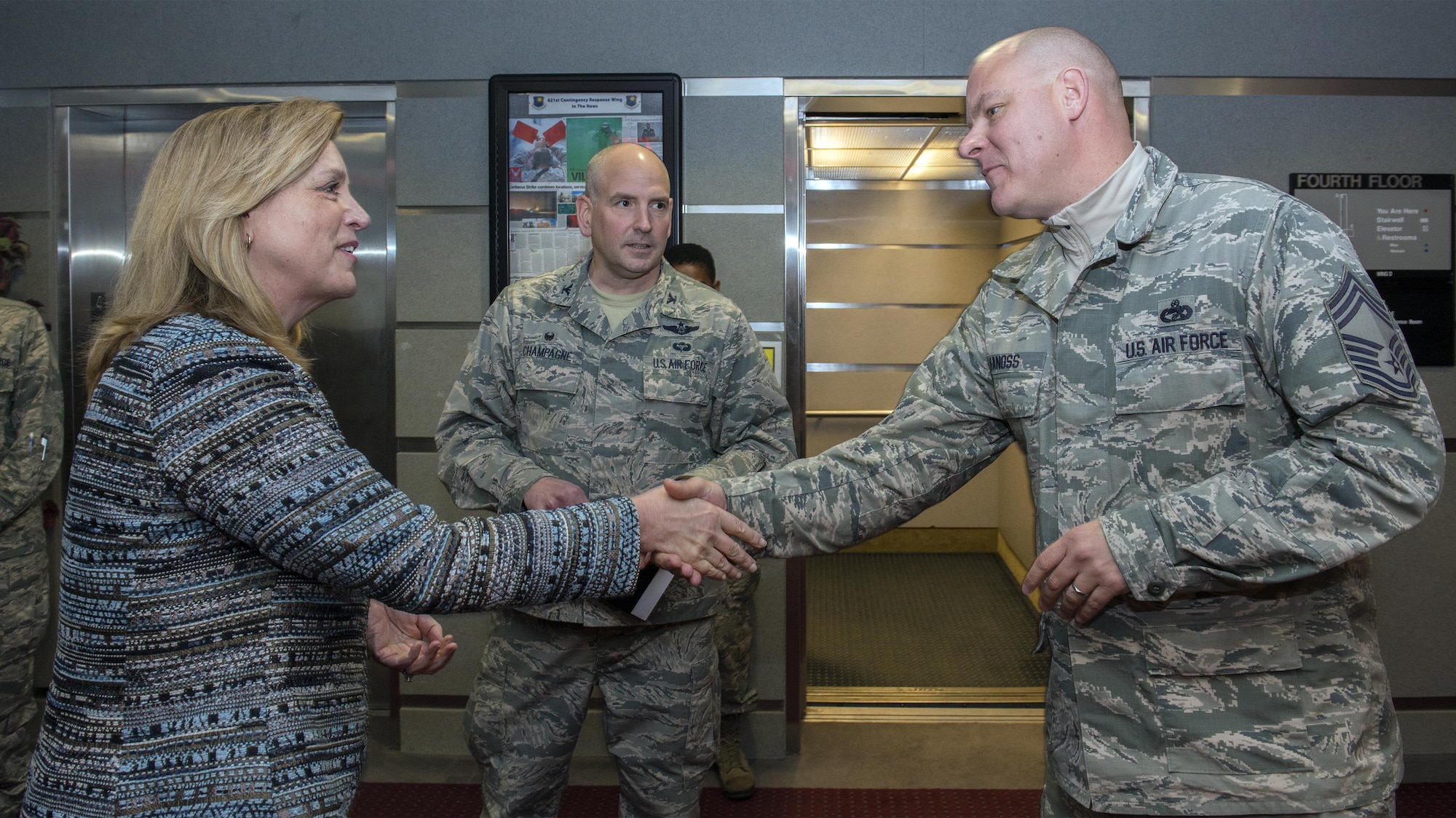 Air Force Secretary Deborah Lee James is greeted by Chief Master Sgt. Jamie Vanoss, the 821st Contingency Response Group superintendent, during her base visit Jan. 8, 2016, at Travis Air Force Base, Calif. James spent a portion of her visit meeting with Airmen from the 621st Contingency Response Wing to gather a greater understanding of their unique mission. (U.S. Air Force photo/Heide Couch)
