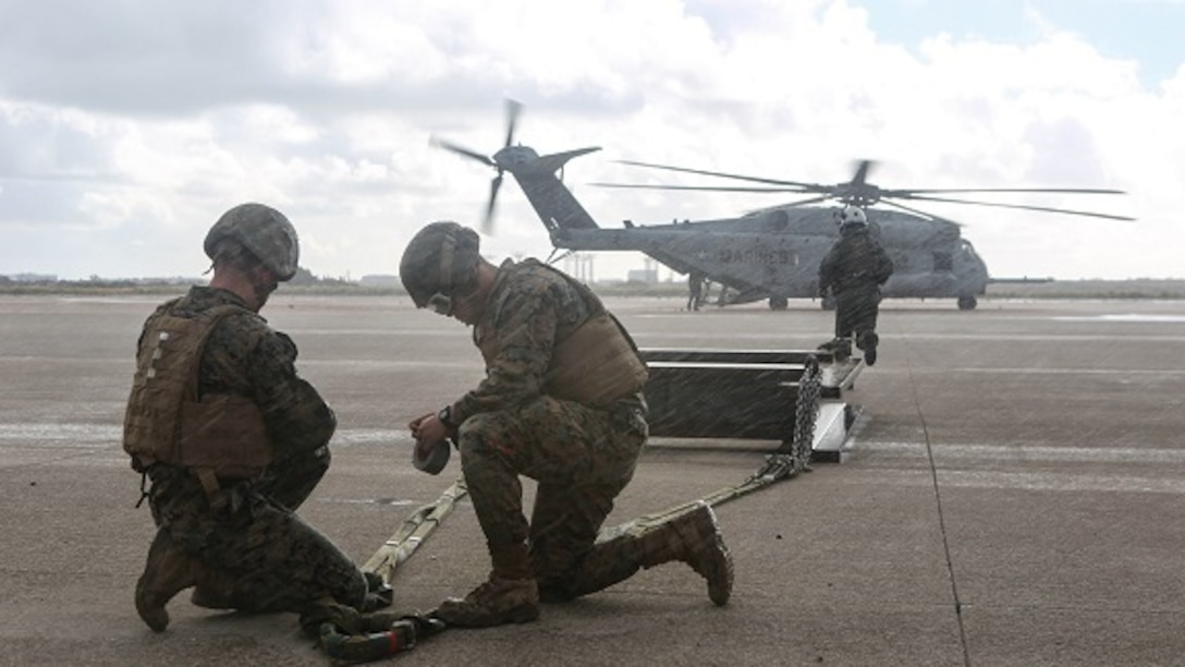 Marines with Combat Logistic Battalion (CLB) 11 prepare a 6,200 pound steel beam for a CH-53E Super Stallion lift aboard Marine Corps Air Station Miramar, Calif., Jan. 7. Marines with Marine Heavy Helicopter Squadron (HMH) 465 and CLB-11 practiced daytime external lift training to prepare for deployments. (U.S. Marine Corps photo by Lance Cpl. Harley Robinson/Released)