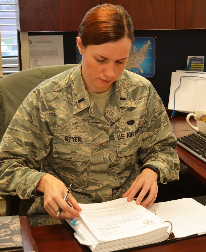 Pennsylvania Air National Guard member, Air Force 1st Lt. Hilary Styer, the 111th Attack Wing’s full-time staff judge advocate, prepares her workspace upon taking on her new role at Horsham Air Guard Station, Pa., Jan. 5, 2016.  Styer is a Pennsylvania native who served as a lawyer in the civilian sector before joining the Air National Guard. Pennsylvania Air National Guard photo by Air Force Tech. Sgt. Andria Allmond