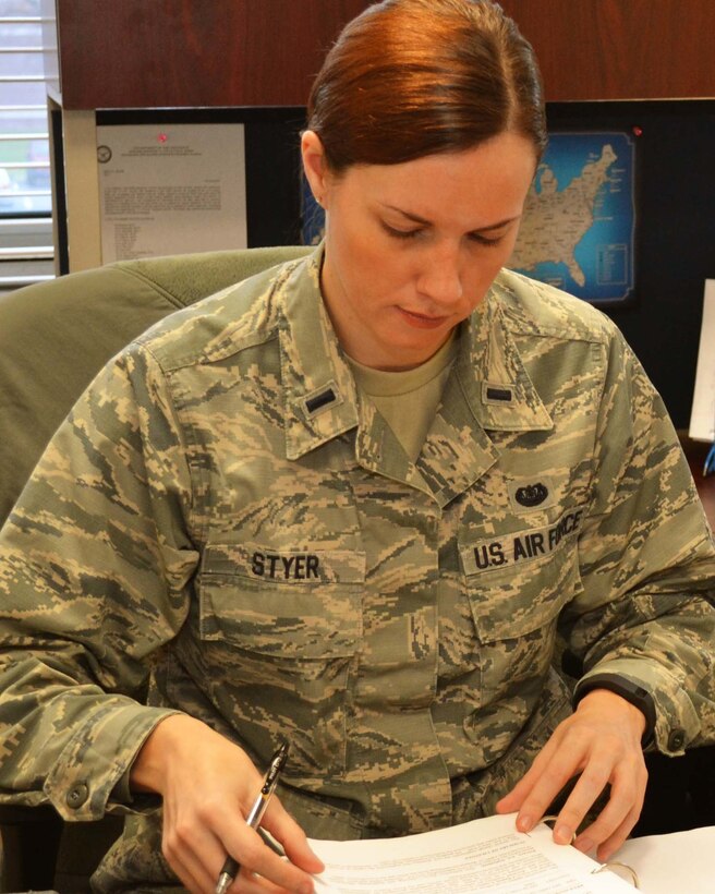First Lt. Hilary Styer, the 111th Attack Wing’s full-time staff judge advocate, prepares her workspace upon taking on the new role Jan. 5, 2015, at Horsham Air Guard Station, Pa. Styer is a Pennsylvania native who served as a lawyer in the civilian sector before joining the Pennsylvania Air National Guard. U.S. Air National Guard photo by Tech. Sgt. Andria Allmond/Released