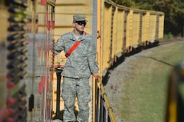 U.S. Army Reserve Pfc. Edward Allen, a railway operations student with the Maritime Intermodal Training Department, surveys the area for hazards at Fort Eustis, Va., Oct. 23, 2015. Along with looking out for hazards, the students also learned rail safety procedures. (U.S. Air Force photo by Staff Sgt. Natasha Stannard)