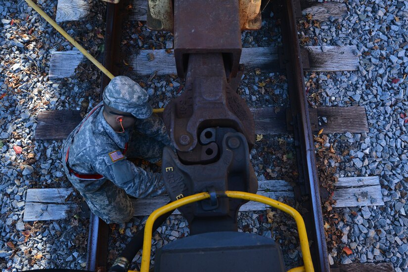 U.S. Army Reserve Pvt. Hunter Ballew, a railway operations student with the Maritime Intermodal Training Department, couples two train cars together at Fort Eustis, Va., Oct. 30, 2015. Learning how to hook the cars was one of the operational aspects of the course, which included conducting and driving the train. (U.S. Air Force photo by Staff Sgt. Natasha Stannard)