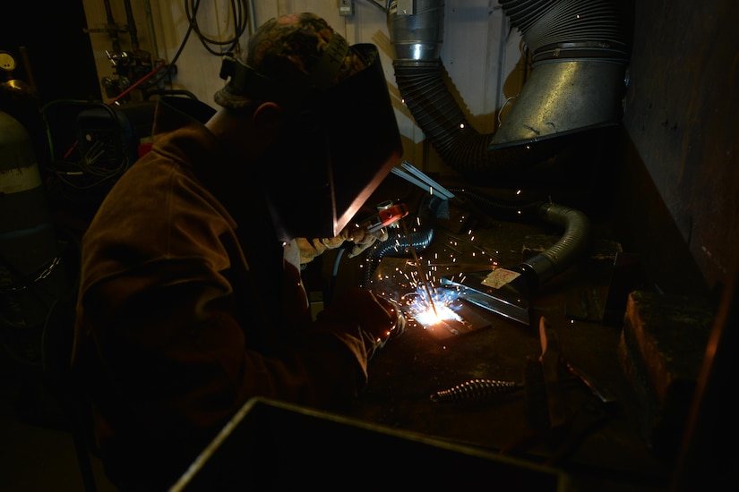 U.S. Army Reserve Pvt. Hunter Ballew, a railway operations student with the Maritime Intermodal Training Department, welds iron metals together during a class at Fort Eustis, Va., Oct. 23, 2015. The welding techniques taught are meant to give students the experience needed to advise on repairing track and machinery. (U.S. Air Force photo by Staff Sgt. Natasha Stannard)