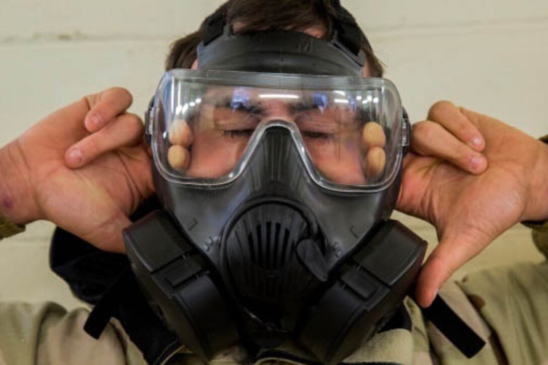 A Marine breaks the seal on his mask after entering the gas chamber on Camp Lejeune, N.C., Jan. 8, 2016. The Marine is assigned to the 2nd Marine Logistics Group. U.S. Marine Corps photo by Lance Cpl. Preston McDonald