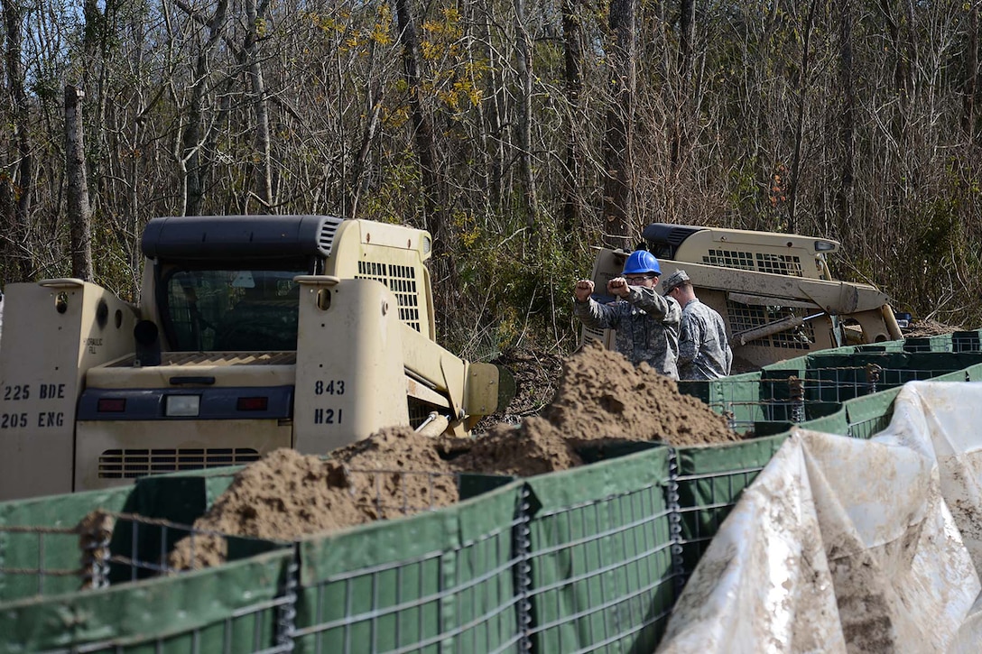 Soldiers continue to work around the clock to assist local officials in ferrying equipment and constructing a levee on Avoca Island, La., Jan. 11, 2016, to protect Morgan City and the surrounding area from high river water. The soldiers used wire-mesh barriers to construct the 2-mile levee. U.S. Army National Guard photos by Spc. Joshua Barnett