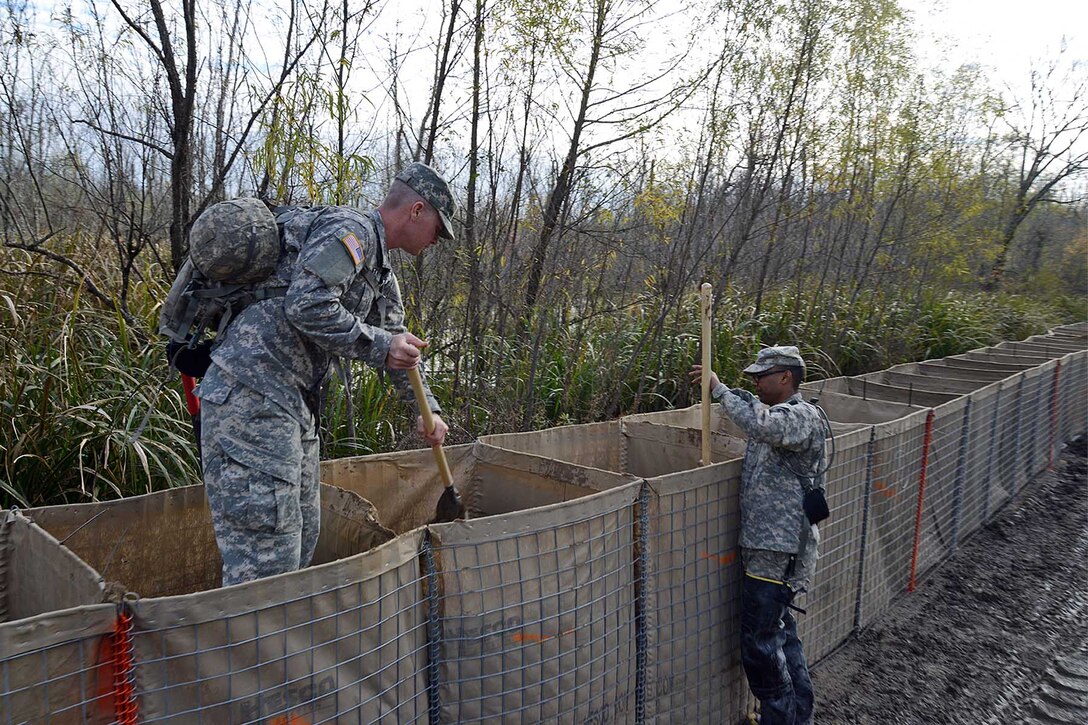 Soldiers continue to work around the clock to assist local officials in  ferrying equipment and constructing a levee with wire-mesh barriers on Avoca Island, La., Jan. 11, 2016, to protect Morgan City and the surrounding area from high river water. U.S. Army National Guard photos by Spc. Joshua Barnett