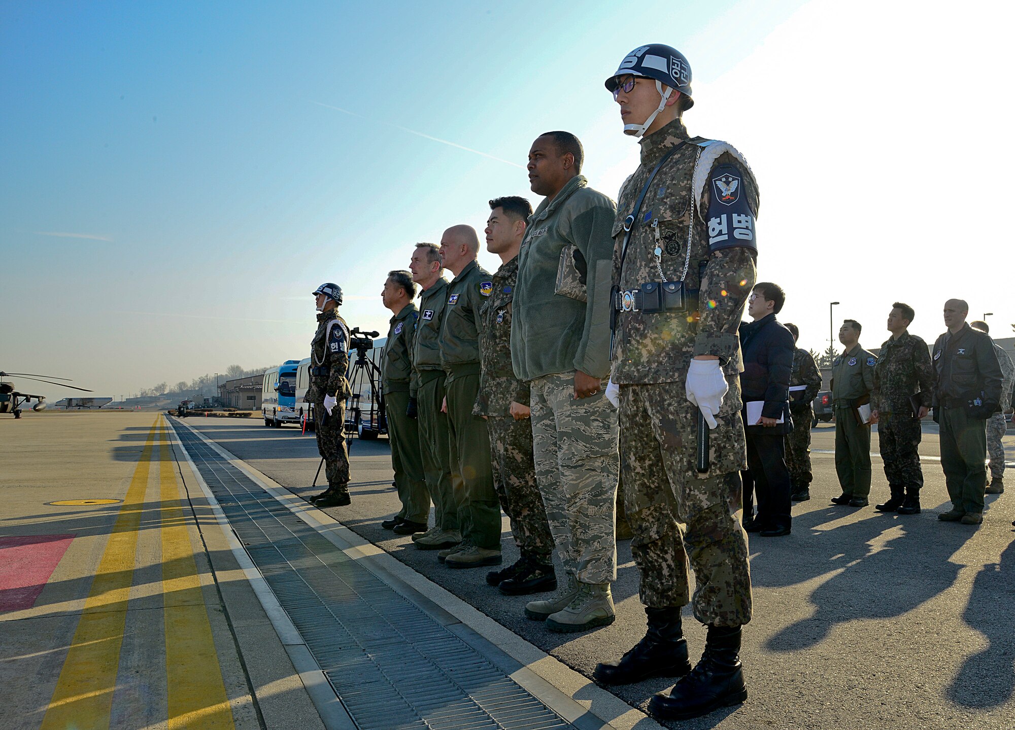 U.S. Forces Korea, 7th Air Force and 51st Fighter Wing leadership await the arrival of Gen. Lee, Sun-Jin, Chairman of the Republic of Korea Joint Chiefs of Staff and Joint Defense Headquarters chief director, to Osan Air Base, ROK, Jan. 11, 2016. During his visit, Lee had the opportunity to visit various locations across the base including an orientation at the Korean Air Operations Center and a static display featuring the 25th and 36th Fighter Squadrons at the weapons load training facility to discuss A-10 Warthog and F-16 Fighting Falcon capabilities and weapons systems. (U.S. Air Force photo by Senior Airman Kristin High/Released)