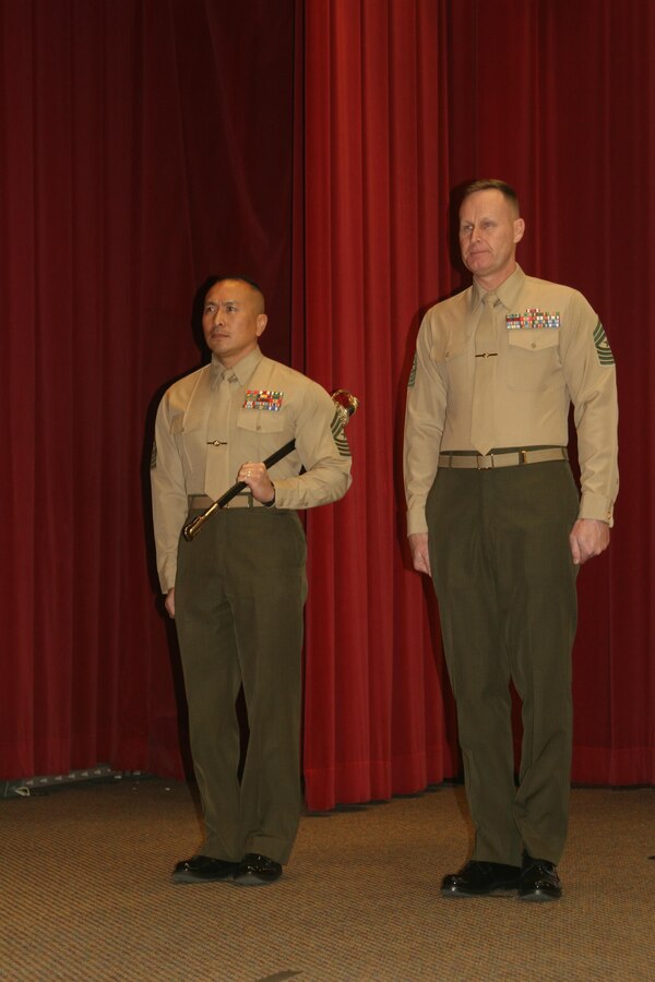 Sgt. Maj. Peter Siaw and Sgt. Maj. David Maddux stand ready for the Education Command relief and appointment ceremony Jan. 4. Siaw holds the sword representing the leadership of the Command Sergeant Major, which was passed to Maddux.