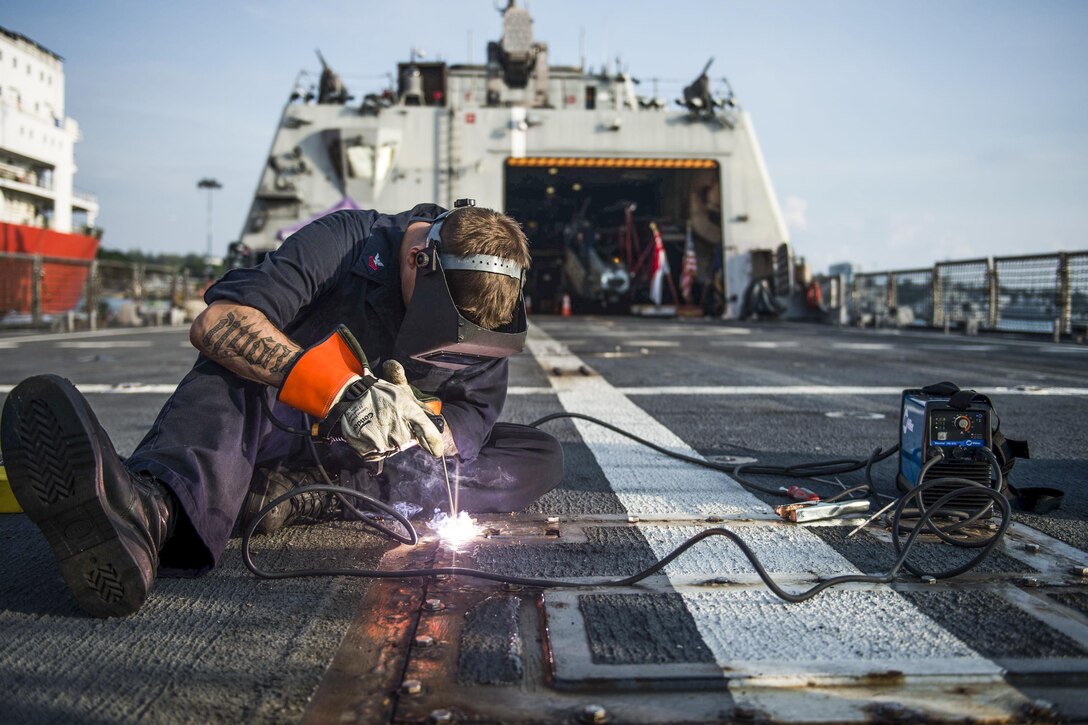 A U.S. sailor secures a bolt in place aboard the USS Fort Worth on Changi Naval Base, Singapore, Jan. 13, 2016. The Fort Worth is on a rotational deployment to support the Asia-Pacific rebalance. U.S. Navy photo by Petty Officer 2nd Class Antonio Turretto Ramos