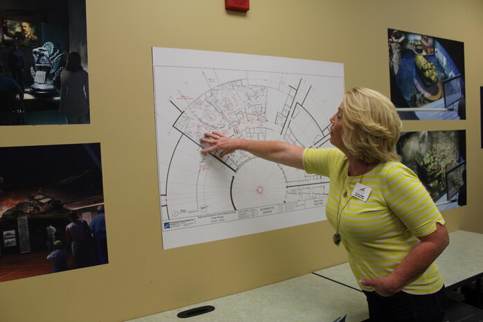 Gwenn Adams, public affairs chief for the National Museum of the Marine Corps, examines the blueprint for the museum’s final phase completion project in September 2015.