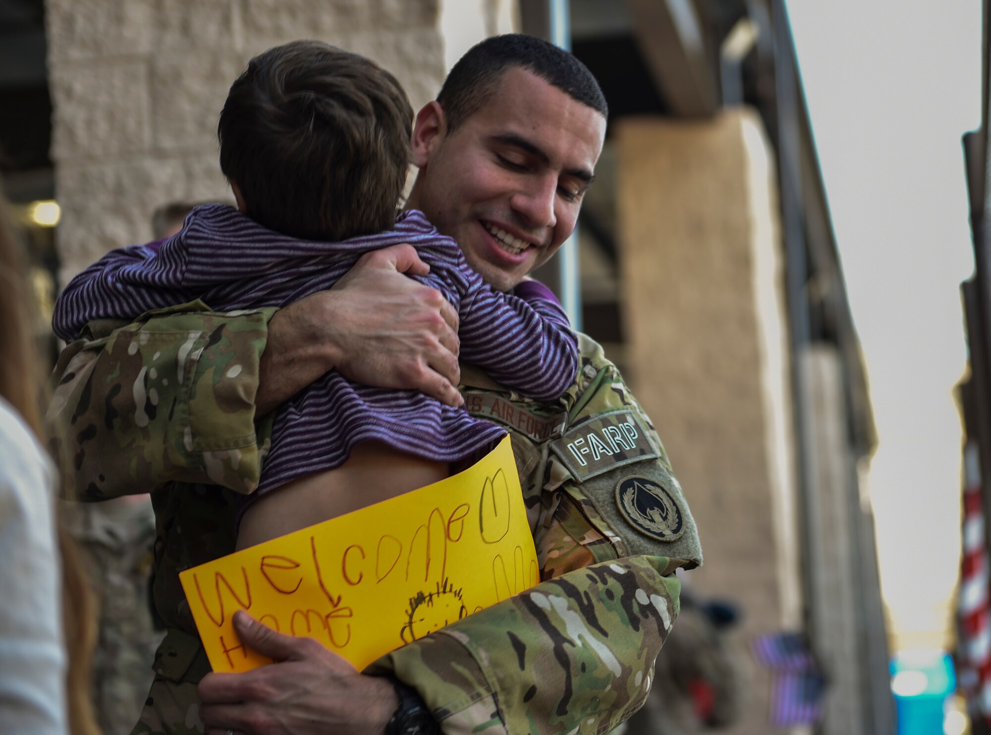 Staff Sgt. Codie Thibodaux, a fuels specialist with the 1st Special Operations Logistics Readiness Squadron, embraces his son during an Operations Homecoming at the Deployment Control Center on Hurlburt Field, Jan. 13, 2016. Operation Homecoming brought approximately 80 Airmen home from their deployment overseas.  (U.S. Air Force photo by Senior Airman Ryan Conroy)