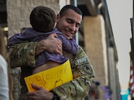 Staff Sgt. Codie Thibodaux, a fuels specialist with the 1st Special Operations Logistics Readiness Squadron, embraces his son during an Operations Homecoming at the Deployment Control Center on Hurlburt Field, Jan. 13, 2016. Operation Homecoming brought approximately 80 Airmen home from their deployment overseas.  (U.S. Air Force photo by Senior Airman Ryan Conroy)