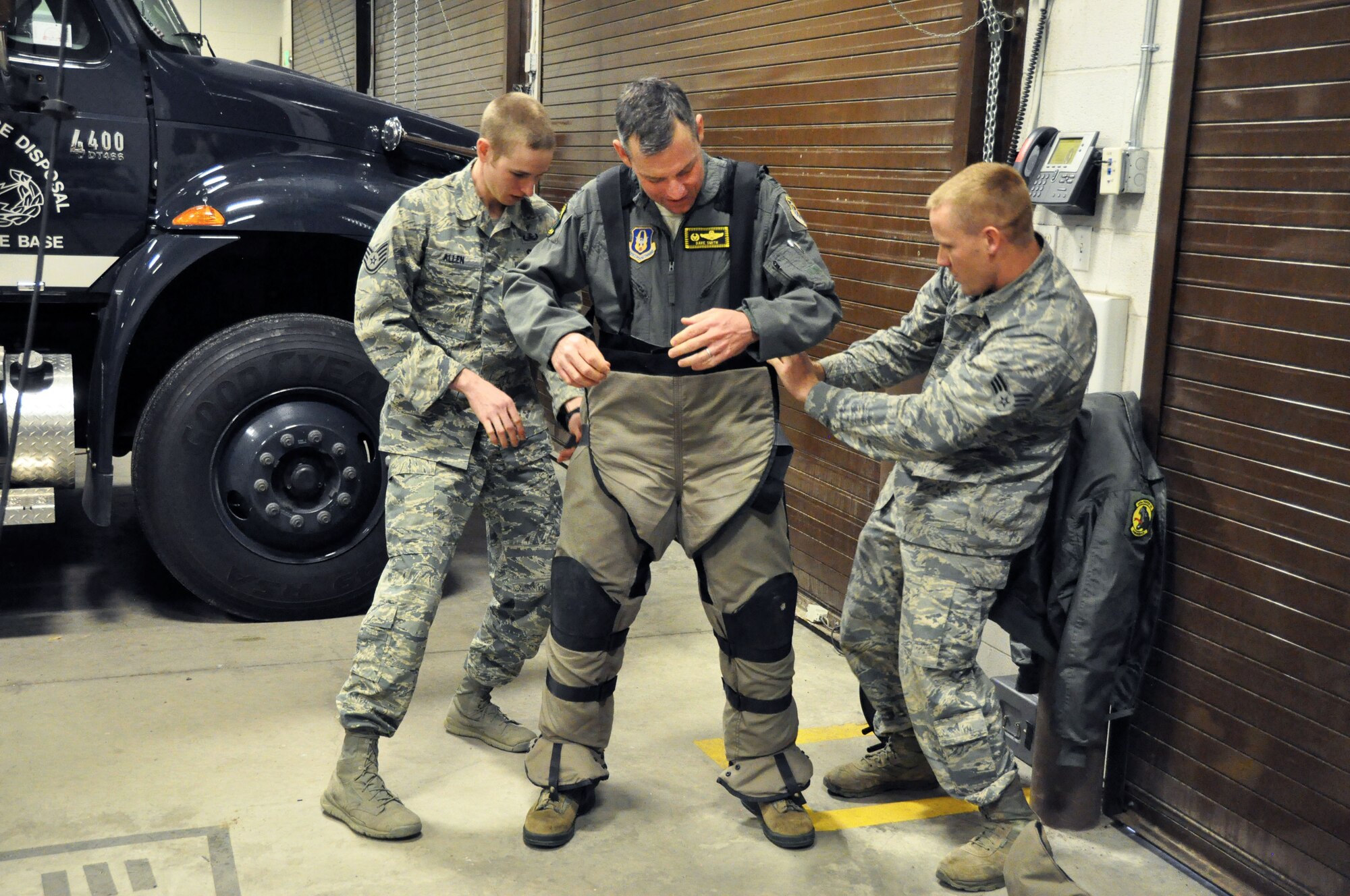 Staff Sgt. James Allen and Senior Airman Wayne Walker, 419th Explosive Ordinance Disposal, assist Col. David Smith, 419th Fighter Wing commander, as he tries on a bomb suit, which provides crucial protection to EOD personnel as they seek and destroy unexploded ordnance. Smith, who took command of the 419th FW in November 2015, spent the afternoon with EOD to learn about the team’s mission and capabilities. (U.S. Air Force photo/Airman 1st Class Justin Fuchs)