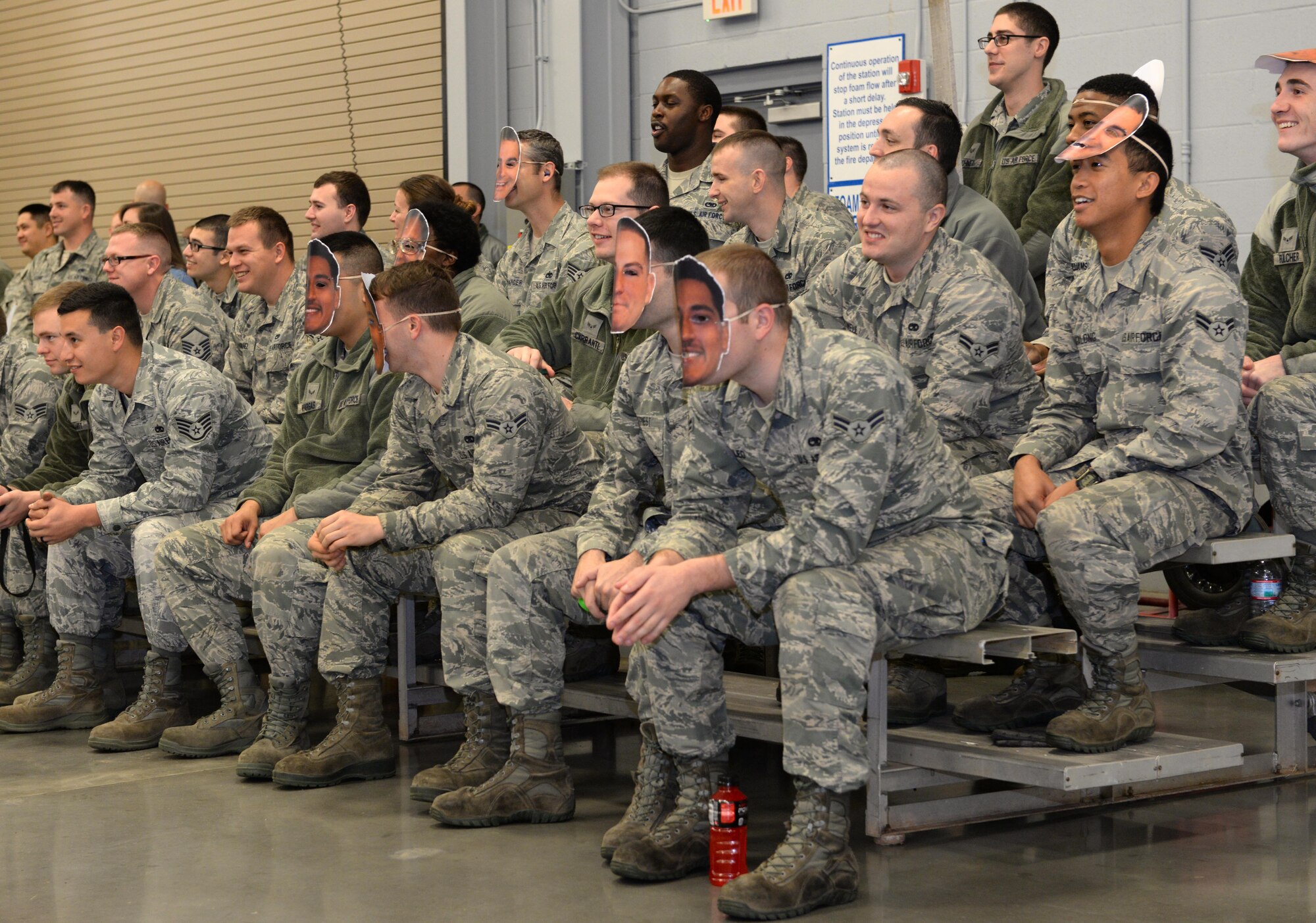 Airmen show support for load crews during the fourth quarter weapons load competition at Barksdale Air Force Base, La., Jan. 7, 2016. Barksdale Airmen regularly compete against one another to determine which team is most proficient at loading a B-52 Stratofortress with a variety of ordnance. (U.S. Air Force photo/Airman 1st Class Curt Beach)