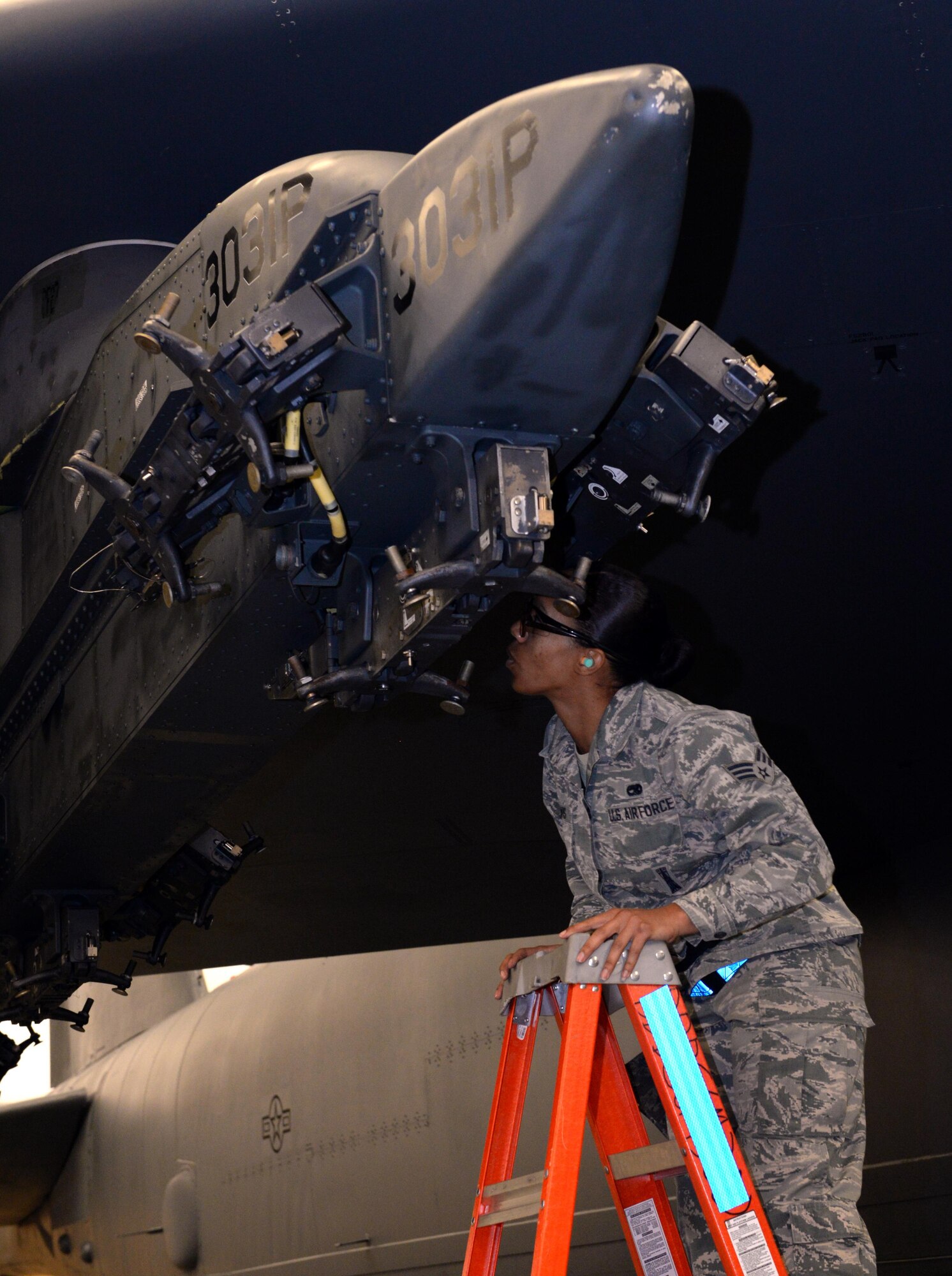 Senior Airman Brittany Davis, 20th Aircraft Maintenance Unit team member, inspects a loading station during a weapons load competition at Barksdale Air Force Base, La., Jan. 7, 2016. For this quarter's competition, each four-person team readied the aircraft and loaded two GBU-38 Joint Direct Attack Munitions onto the aircraft's two exterior weapon pylons. (U.S. Air Force photo/Airman 1st Class Curt Beach)