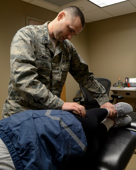Capt. Scott Cheney, 2nd Medical Operation Squadron physical therapy element commander, evaluates a patient during a follow-up appointment at Barksdale Air Force Base, La., Jan. 12, 2016. The 2nd MDOS physical therapy clinic is now seeing military members with acute sport injuries to include sprains and other muscle or joint related pain without a referral from a primary care manager. (U.S. Air Force photo/Senior Airman Jannelle Dickey)