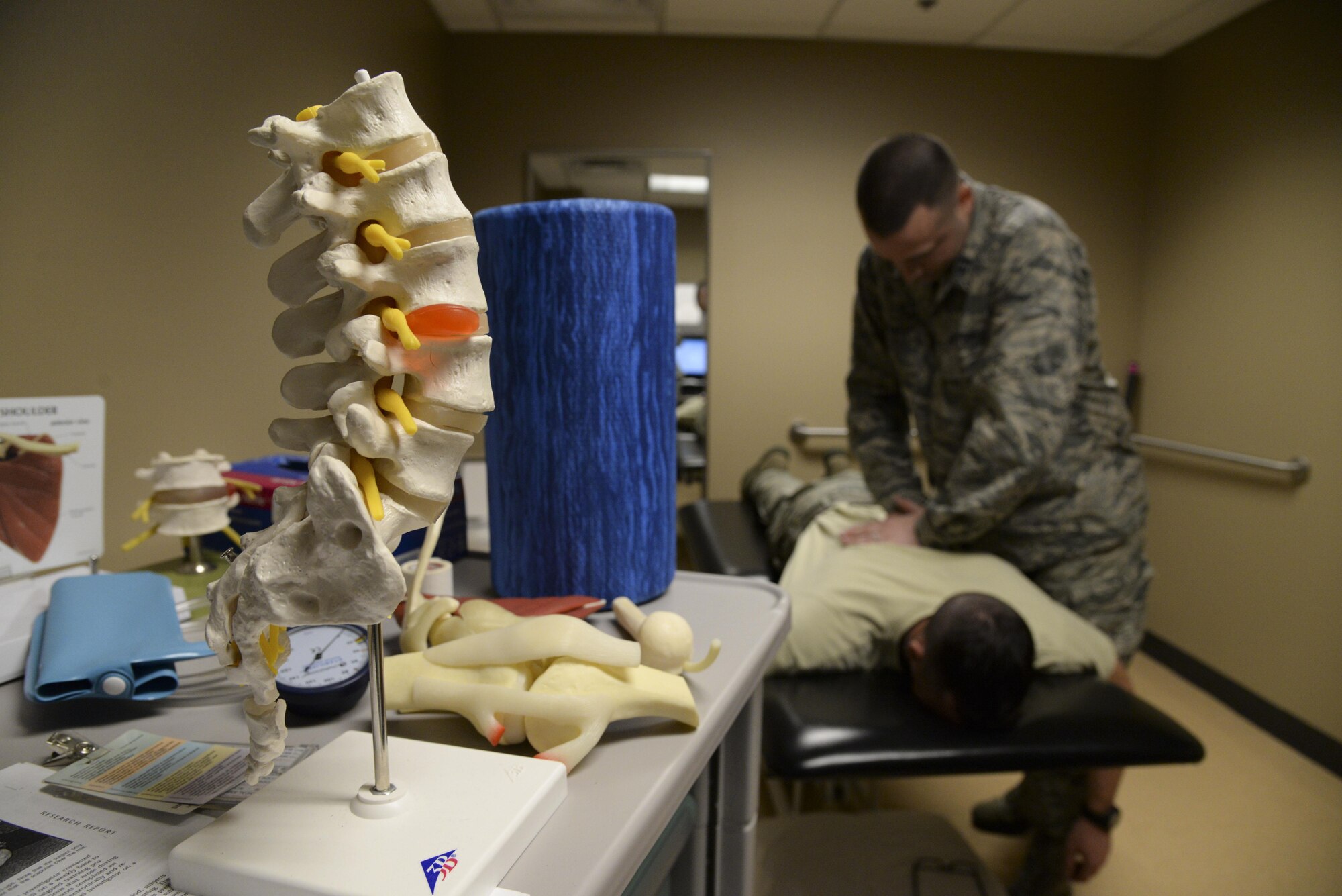 Capt. Scott Cheney, 2nd Medical Operation Squadron physical therapy element commander, manipulates a patient’s back during a follow-up appointment at Barksdale Air Force Base, La., Jan. 12, 2016. A follow-up is required to evaluate a patient’s progress to ensure home exercises and treatments were effective. The 2nd MDOS physical therapy clinic is now seeing military members with acute sport injuries to include sprains and other muscle or joint related pain without a referral from a primary care manager. (U.S. Air Force photo/Senior Airman Jannelle Dickey)