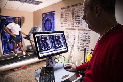 Karl Leonard, Joint Base San Antonio-Randolph Human Performance Resource Center exercise physiologist, points out the
improvements that could be made in a client's running form after an analysis session Dec. 9, at the JBSA-Randolph HPRC.