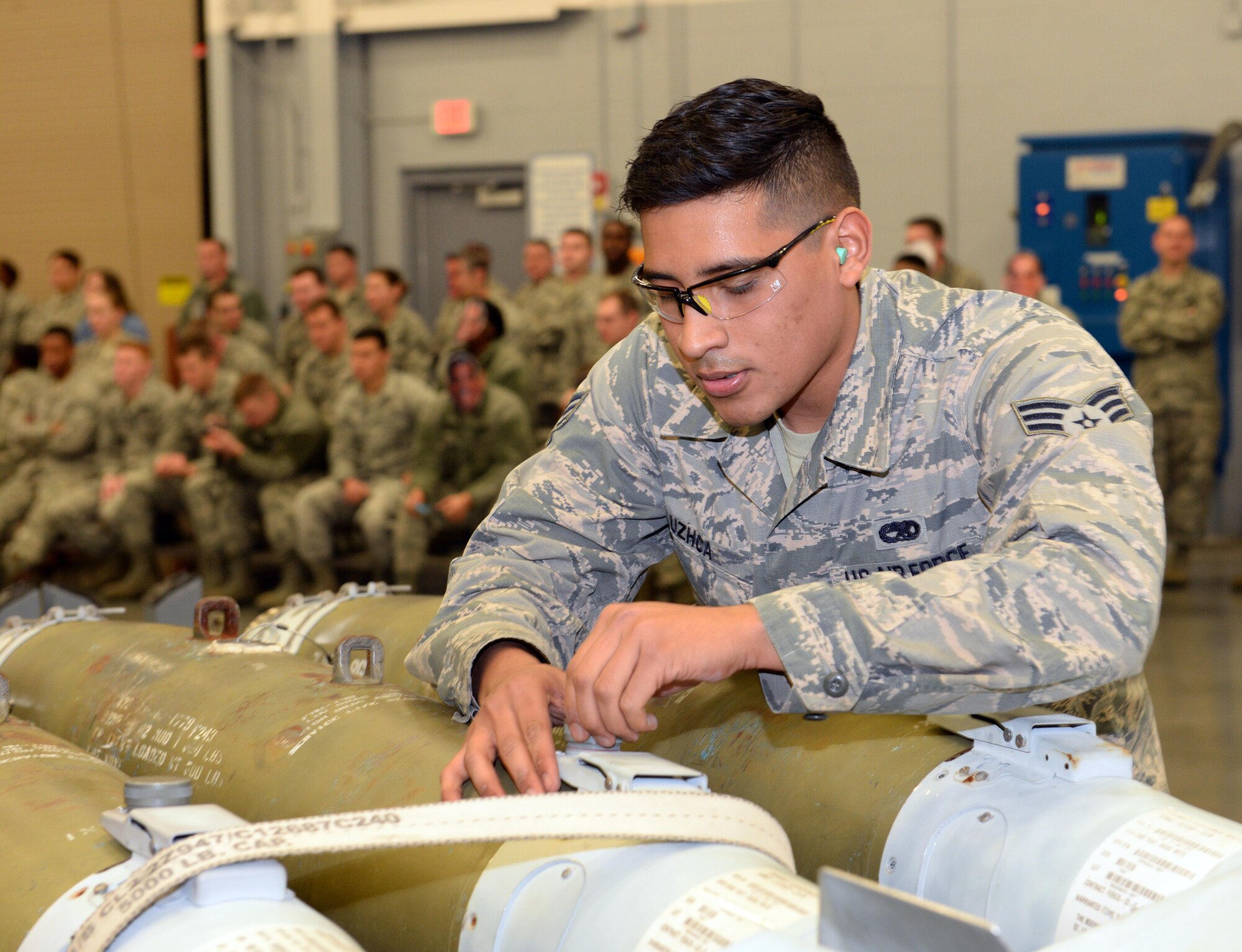 Senior Airman Christopher Uzhca, 20th Aircraft Maintenance Unit team member, inspects munitions during a weapons load competition at Barksdale Air Force Base, La., Jan. 7, 2016. Uzhca was his team’s “3 man,” responsible for making sure all the correct munitions were prepared for loading onto the B-52 Stratofortress. (U.S. Air Force photo/Airman 1st Class Curt Beach)