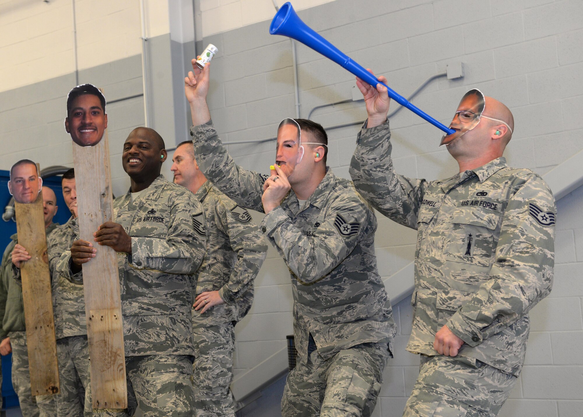 Fans show their enthusiasm at the fourth quarter weapons load competition at Barksdale Air Force Base, La., Jan. 7, 2016. Barksdale Airmen regularly compete against one another to determine which team is most proficient at loading a B-52 Stratofortress with a variety of ordnance. (U.S. Air Force photo/Airman 1st Class Curt Beach)
