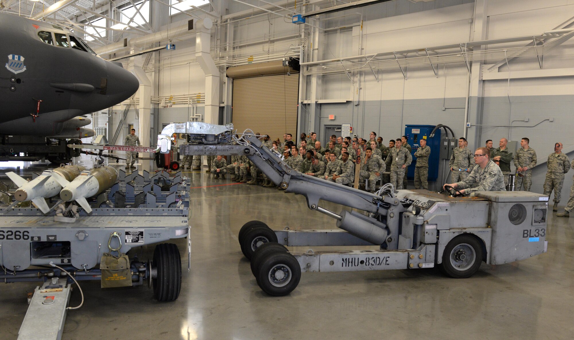 Senior Airman Brandon Barber, 96th Aircraft Maintenance Unit Cobra 7 load crew, operates an MHU-83 loader during the fourth quarter weapons load competition at Barksdale Air Force Base, La., Jan. 7, 2016. The load crews used the MHU-83 to transport munitions from the trailer to the B-52 Stratofortress pylon. (U.S. Air Force photo/Airman 1st Class Curt Beach)