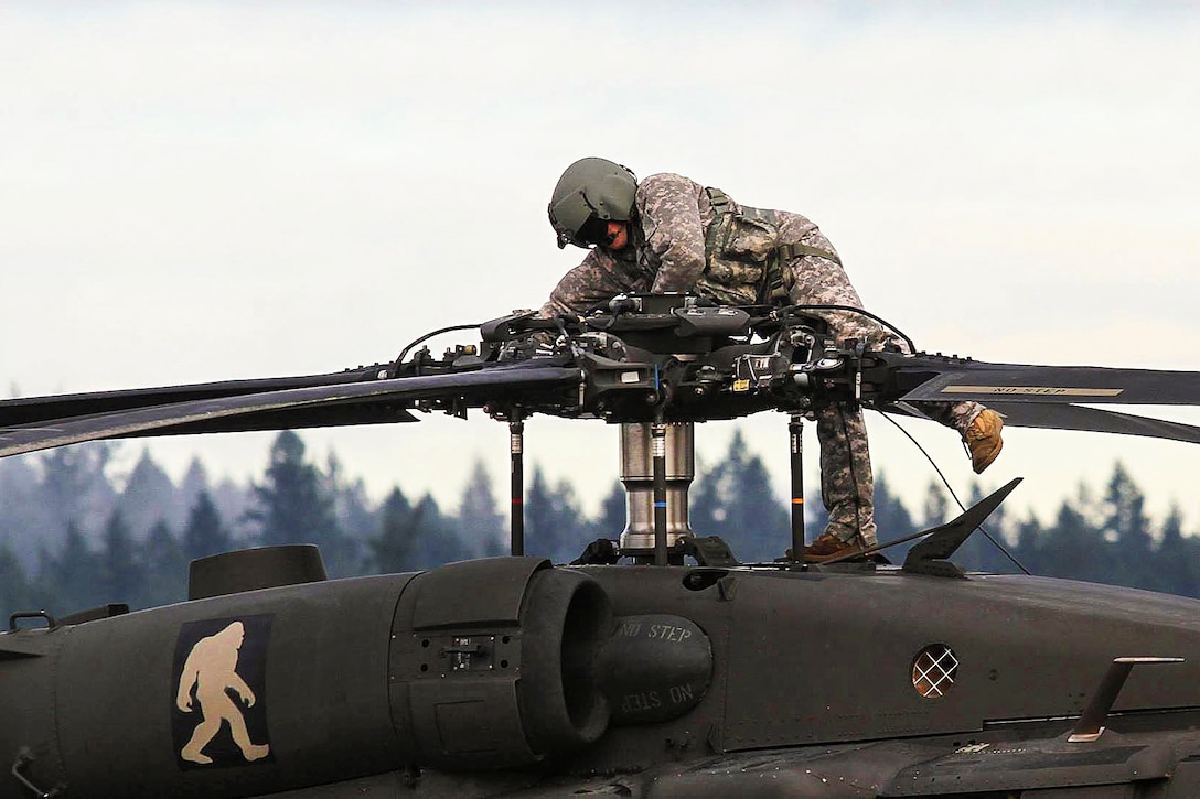 A soldier prepares a UH-60 Black Hawk on Joint Base Lewis-McChord, Wash., Jan. 9, 2016, to fly to the National Training Center on Fort Irwin, Calif. The soldier is assigned to the 7th Infantry Division's 2nd Battalion, 158th Aviation Regiment, 16th Combat Aviation Brigade. U.S. Army photo by Capt. Brian Harris
