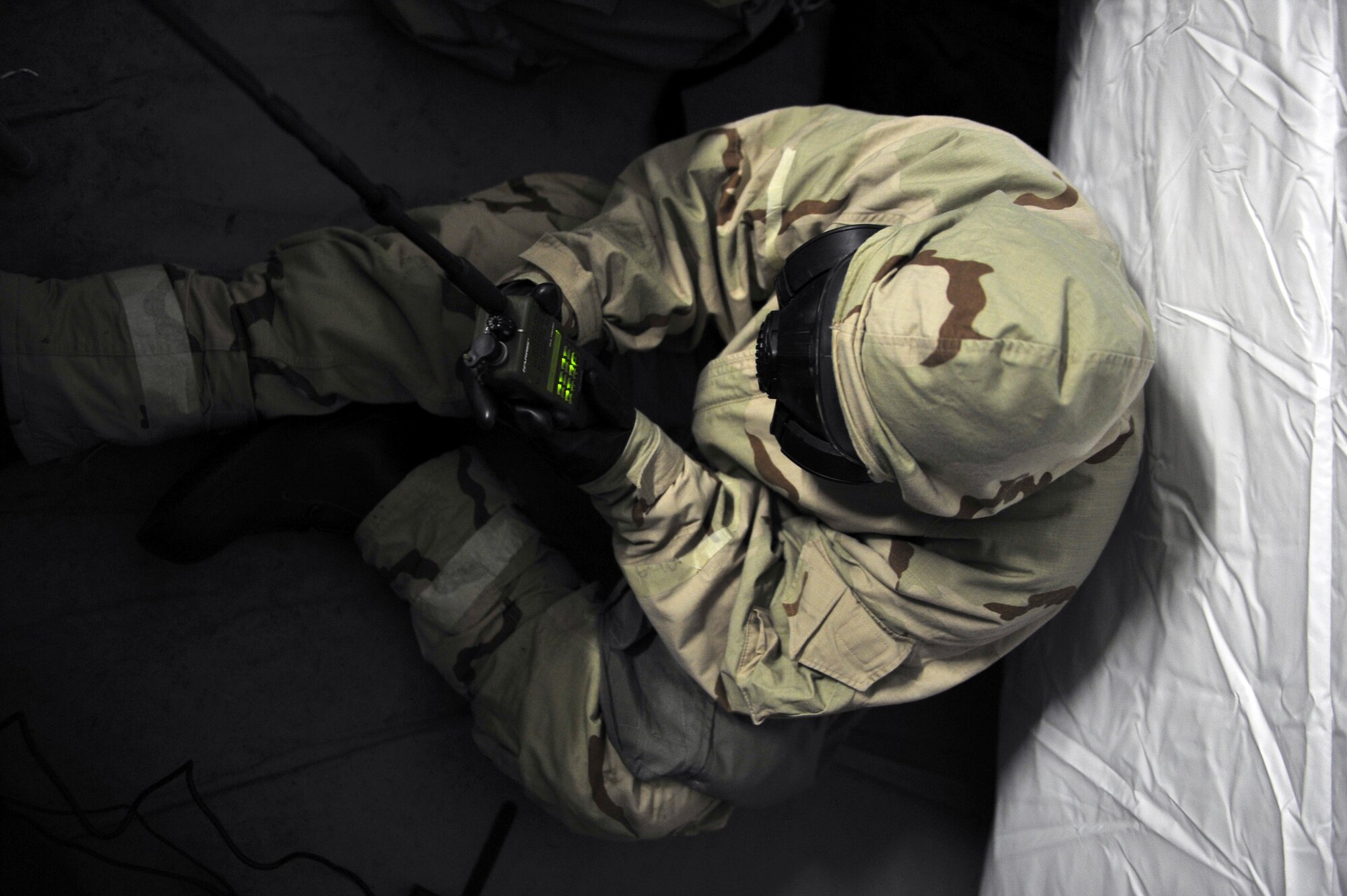 Staff Sgt. Genea Wright, Customer Support NCO-in-charge with the 1st Special Operations Wing Staff Agency, checks her radio during a simulated chemical attack as part of exercise Frigid Archer 2016 at Eglin Range, Fla., Jan. 9, 2016. Frigid Archer tested 1st SOW Air Commandos’ expertise through a myriad of operational and support requirements. (U.S. Air Force photo by Staff Sgt. Tyler Placie)