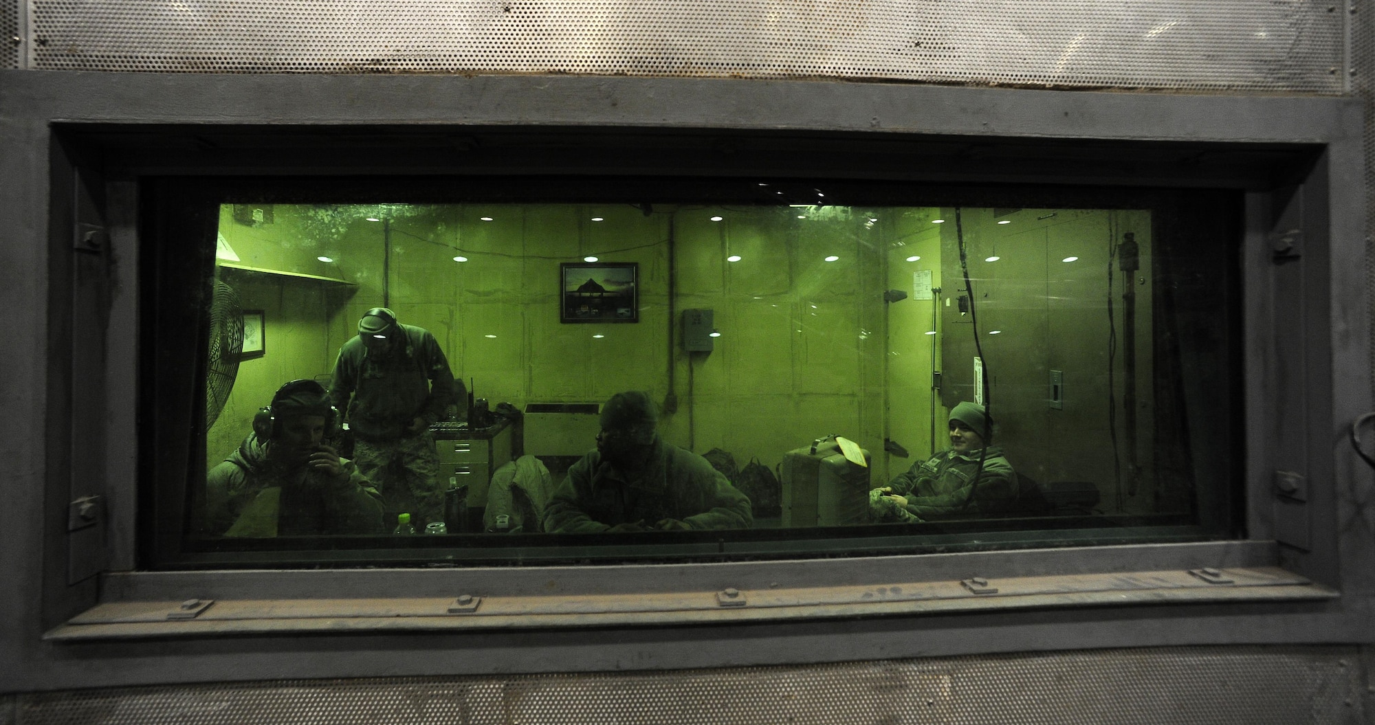 Airmen from the 8th Maintenance Squadron run controls in the hush house during an F-16 Fighting Falcon engine test at Kunsan Air Base, Republic of Korea, Dec. 9, 2015. In addition to the hush house, the 8th MXS maintenance flight encompasses multiple duty sections, which include a tire shop, aerospace propulsion, crash damage, aircraft recovery and phase.  (U.S. Air Force photo by Staff Sgt. Nick Wilson/Released)