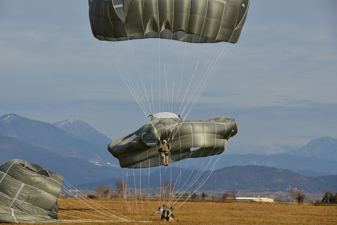 U.S. paratroopers land after conducting airborne operations from a U.S. Air Force C-130 Hercules over the Juliet drop zone in Pordenone, Italy, Jan. 8, 2016. U.S. Army photo by Massimo Bovo