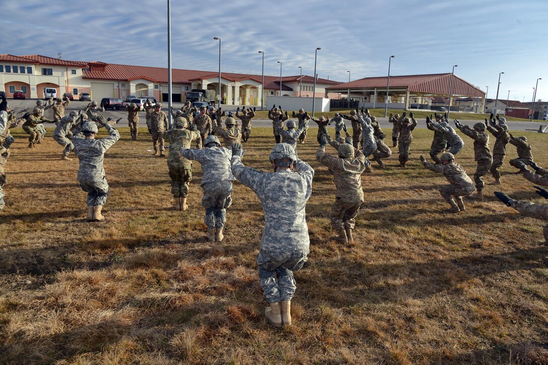 U.S. Army paratroopers pratice hooking up to the static line on Aviano Air  Base, Italy, before