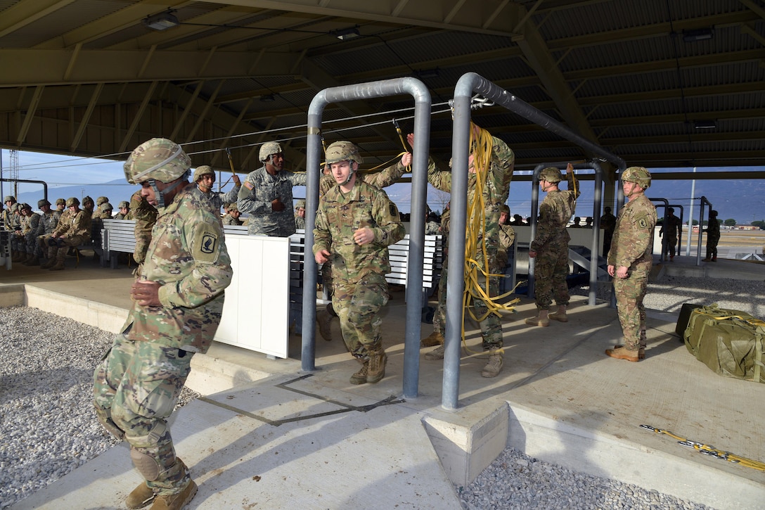 U.S. paratroopers practice door exits on the mock door trainer at Aviano Air Base, Italy, before participating in airborne operations on the Juliet drop zone in Pordenone, Italy, Jan. 8, 2016. U.S. Army photo by Massimo Bovo