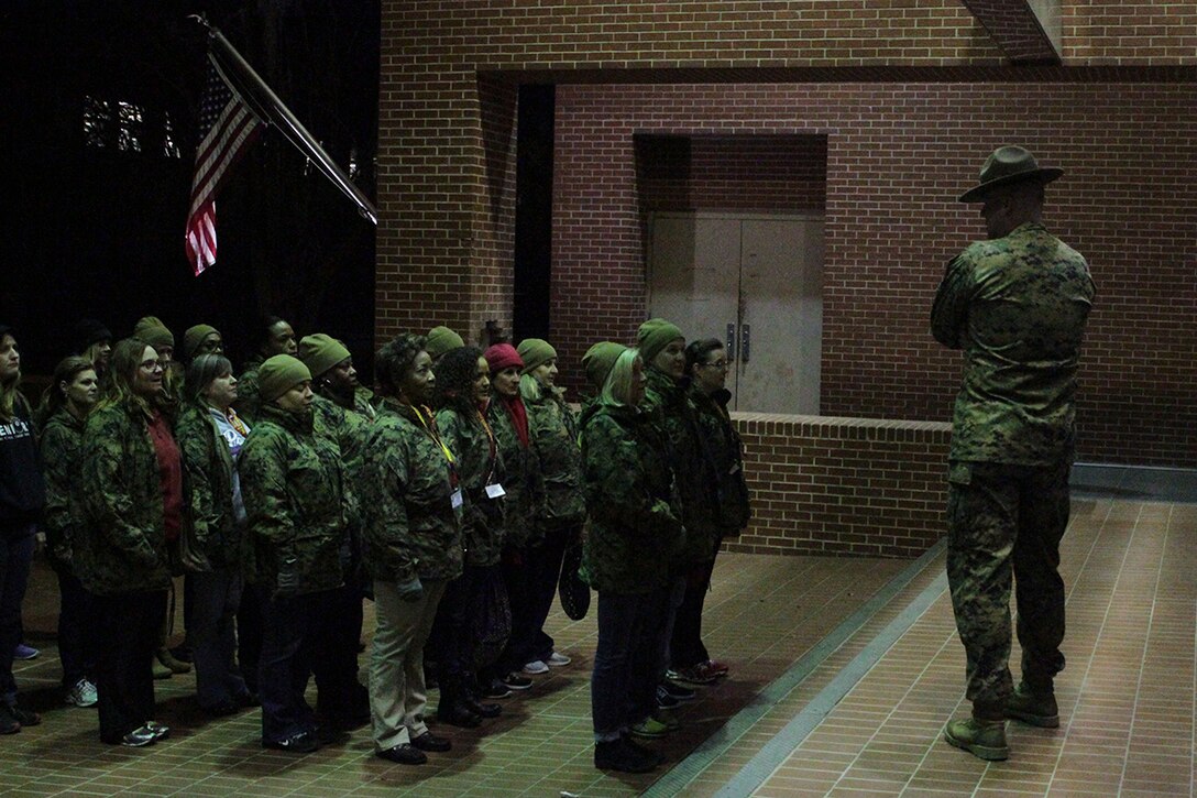 Educators from both Recruiting Stations Orlando and Fort Lauderdale stand in formation as the drill instructors give them a small brief about a portion of the recruit training aboard Marine Corps Recruit Depot Parris Island, S. C., January 13, 2016. The three-day workshop will give the educators a chance to experience the day to day routines aboard the depot and Marine Corps Air Station Beaufort, with the main purpose of giving the educators a better understanding of the Marine Corps. (Official Marine Corps photo by Cpl. Diamond Peden)