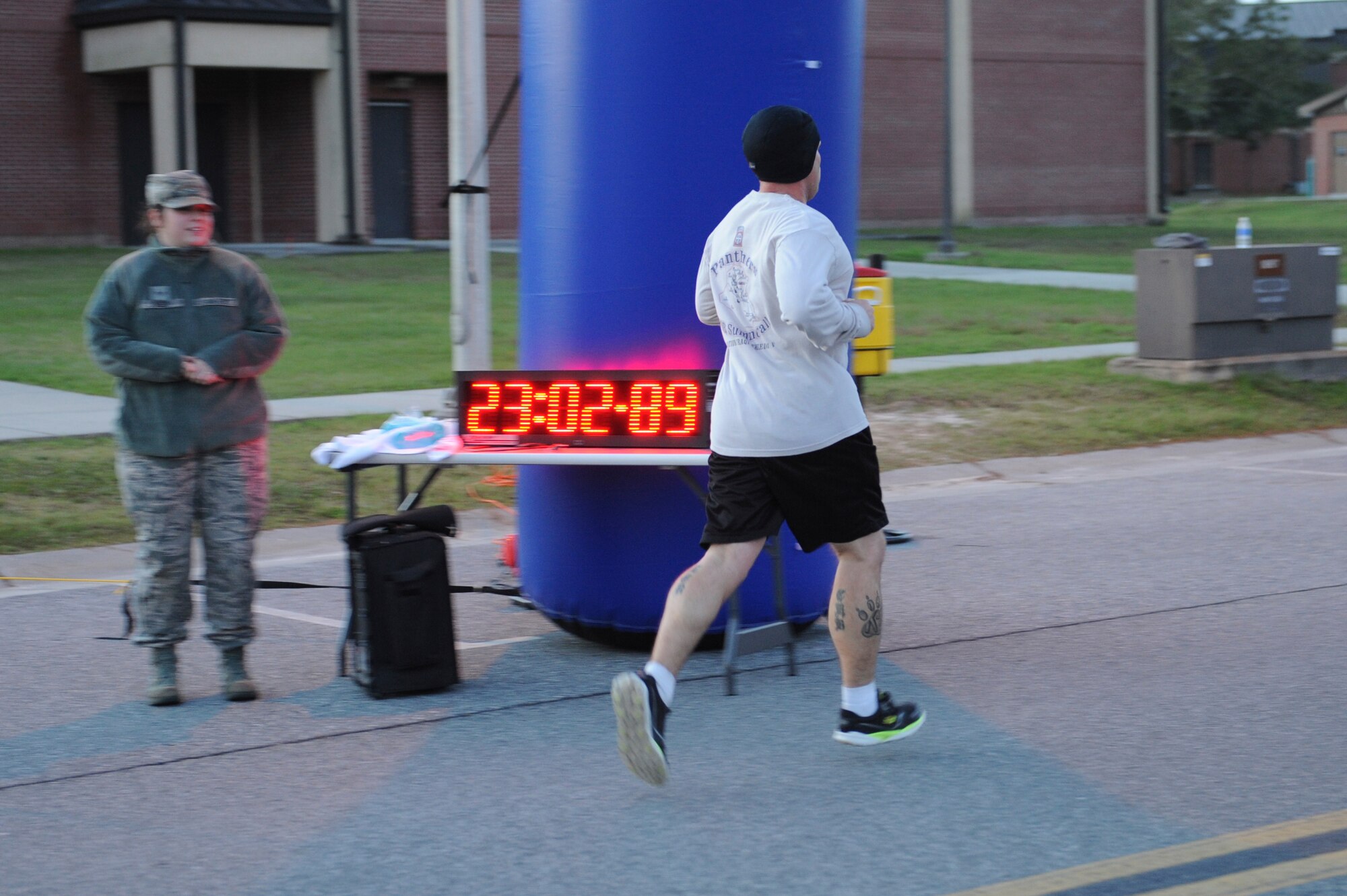 U.S. Air Force Tech. Sgt. Thomas Blandino, 820th Combat Operations Squadron military working dog kennel master, crosses the finish line during the Martin Luther King Jr. Day 5k, Jan. 13, 2016, at Moody Air Force Base, Ga. Blandino was the first person to finish the run, with a time of 23 minutes. (U.S. Air Force photo by Airman 1st Class Kathleen D. Bryant/Released) 
