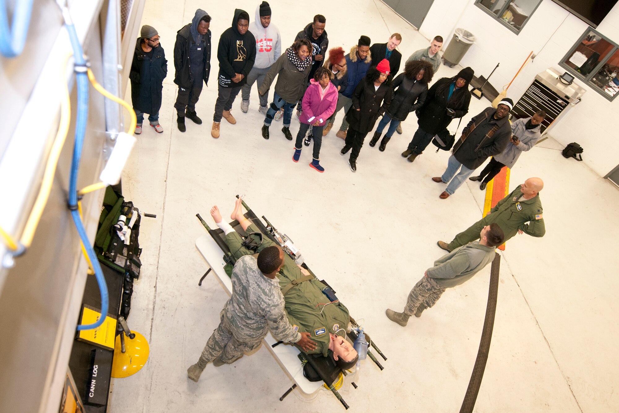 Members of the 459th Aeromedical Evacuation Squadron inform Luke C. Moore Academy students about a career as an in-flight transportation medic during a tour here Jan. 7, 2016. The tour included presentations from a 459th pilot, boom operator and in-flight medics. (U.S. Air Force photo by Staff Sgt. Kat Justen)