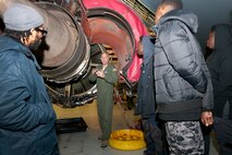 Lieutenant Col. Lanson Ross III, 459th Operations Group chief of operations, explains the mechanics and function of a KC-135R Stratotanker engine to a group of Luke C. Moore Academy students during a tour here Jan. 7, 2016. Students were able to tour the cockpit, boom pod and cargo hold as well as speak with a pilot, boom operator and in-flight medics during their visit. (U.S. Air Force photo by Staff Sgt. Kat Justen)