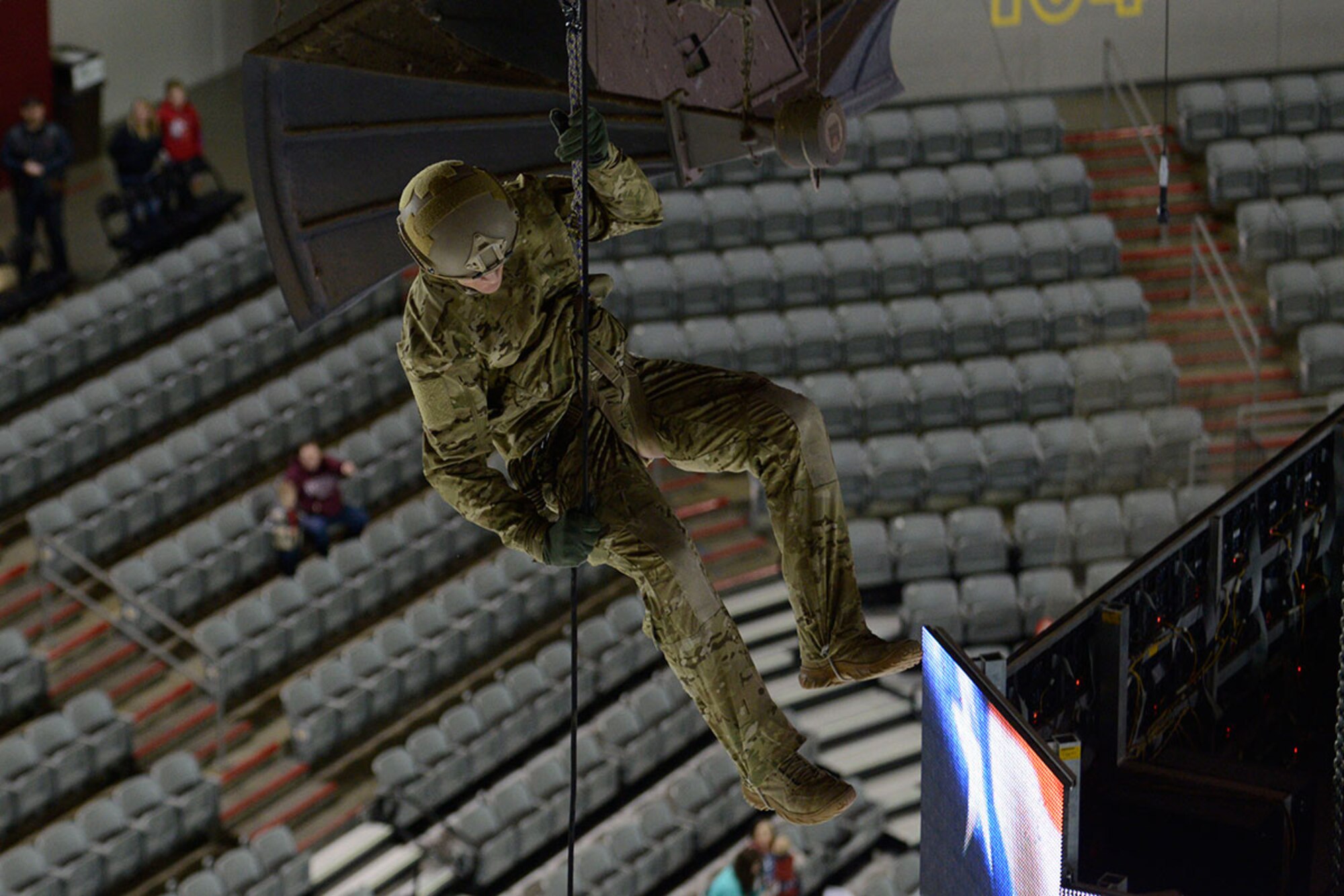 Master Sgt. Shane Hargis, 212th Rescue Squadron pararescueman, rappels from the rafters during the Joint Base Elmendorf-Richardson Army vs. Air Force hockey game. The game promoted esprit de corps and was intended to enhance the relationship between JBER and the Anchorage community.  (U.S. Air Force photo by Airman Valerie Monroy)