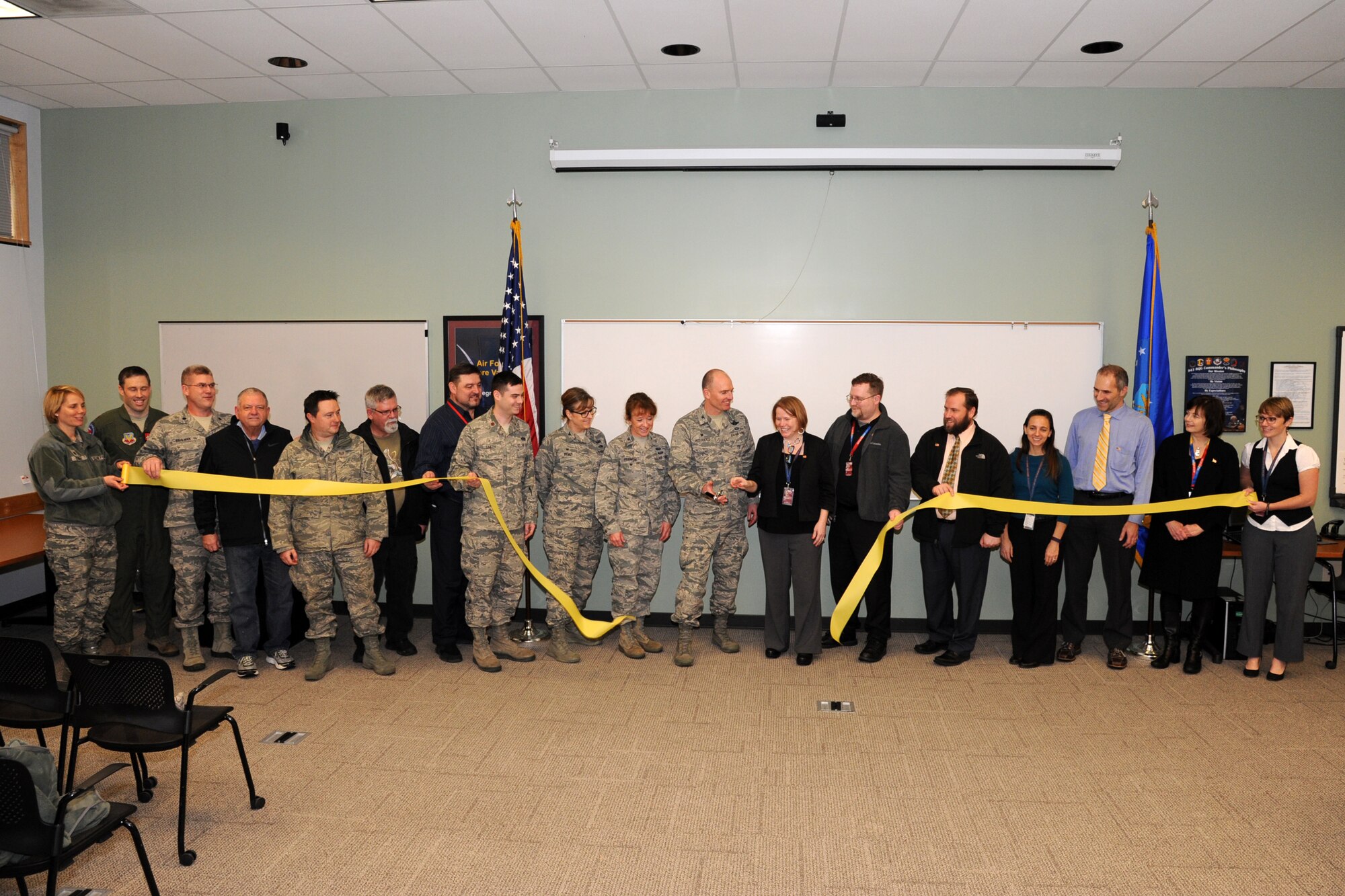 Senior leaders from the 142nd Fighter Wing and the Port of Portland cut the ceremonial ribbon to signify the Oregon Air National Guard’s return of 27 acres, 4 buildings and 52 percent of the west ramp of PDX to the Port of Portland during a ceremony held at the Portland Air National Guard Base, Ore., Jan. 13, 2016. (U.S. Air National Guard photo by Master Sgt. Shelly Davison, 142nd Fighter Wing Public Affairs)