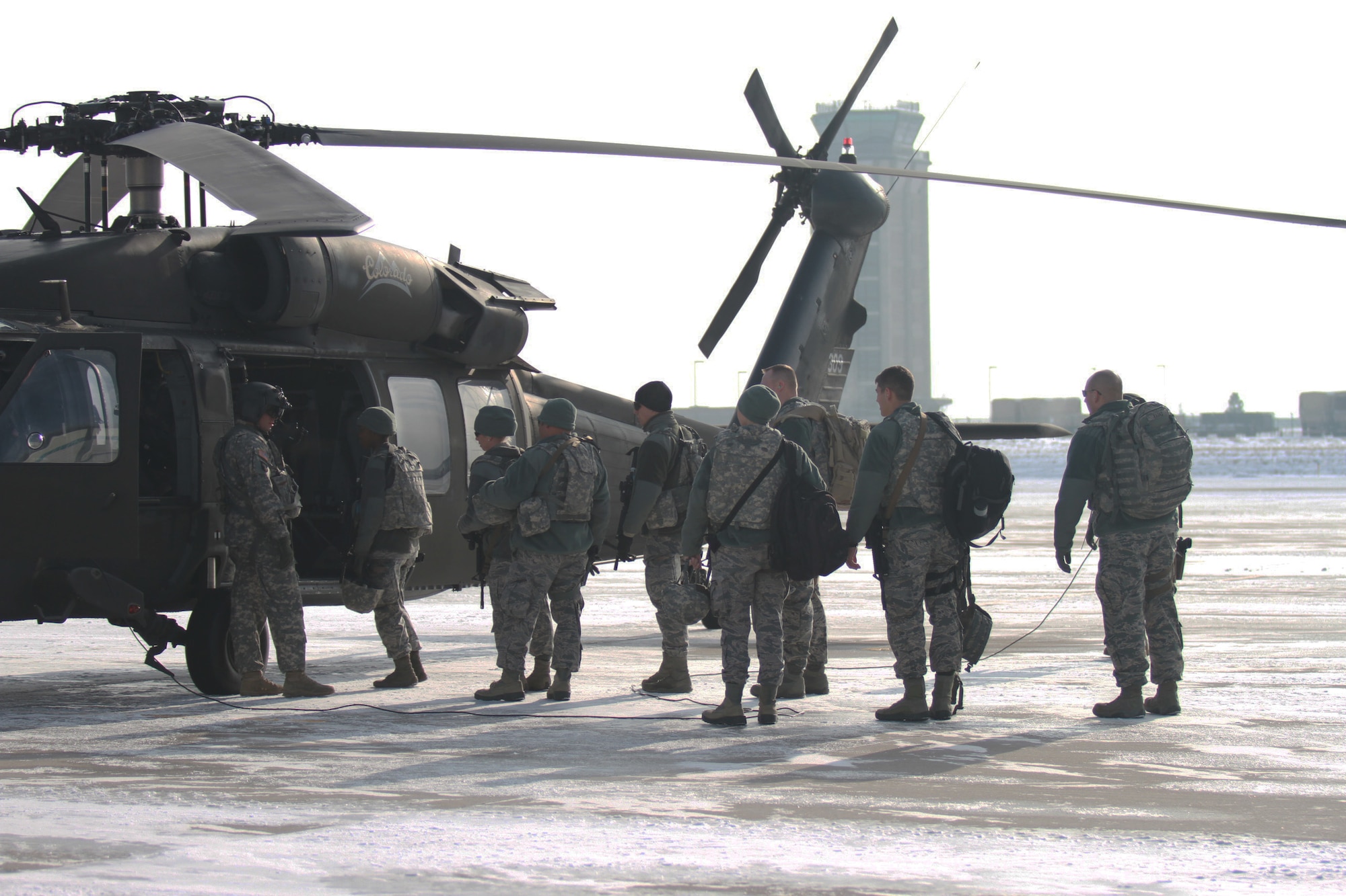 U.S. Airmen from the Colorado National Guard's 140th Security Squadron board a UH-60 Black Hawk helicopter in support of a blizzard response exercise at Buckley Air Force Base, Aurora, Colo., Jan. 9, 2016. Colorado Guard members and various local agencies are participating in a blizzard response exercise with local authorities this week. (U.S. National Guard photo by Spc. Ashley Low/)